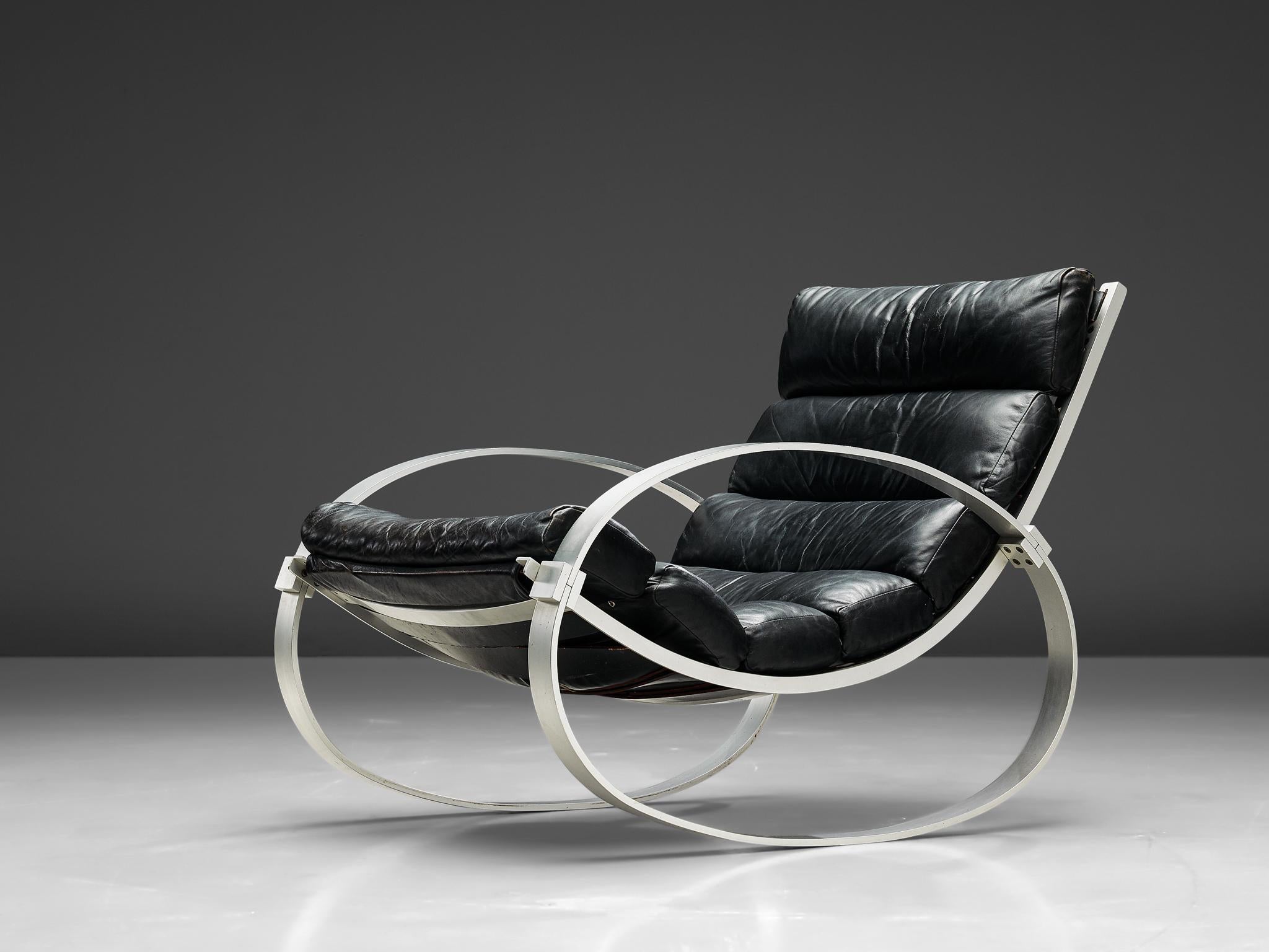 Hans Kaufeld, rocking chair, aluminium and leather, Germany, 1970s.

Modernist rocking lounge chair with matching ottoman designed by Hans Kaufeld, Germany features its original black leather rolled upholstery with brushed steel frame.

