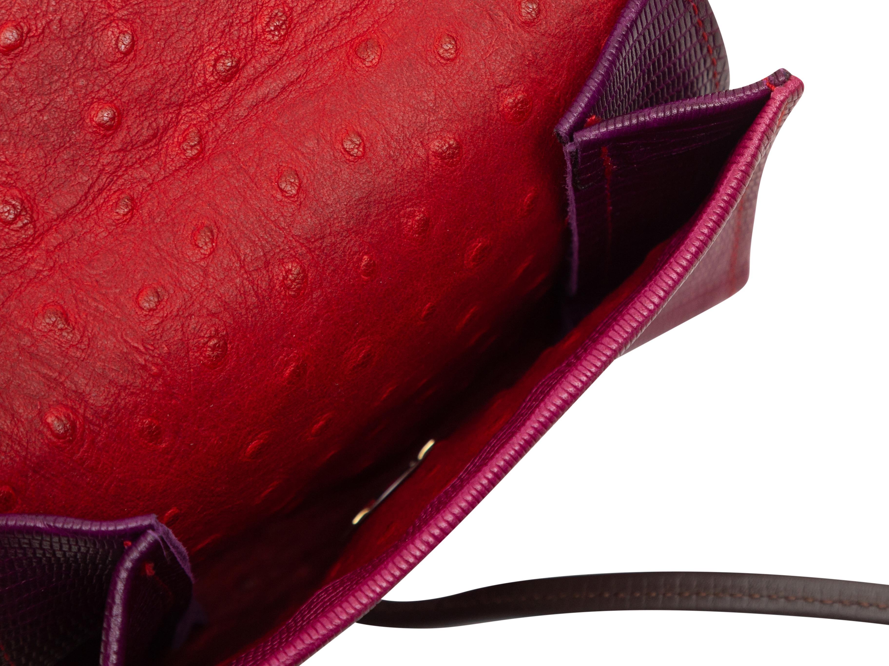 Product details: Fuchsia and red embossed leather crossbody bag by Hans Koch. Black leather shoulder strap. Magnetic closure at front flap. 6