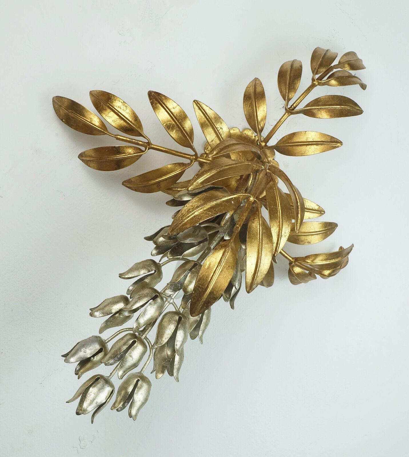 Very beautiful and decorative wall lamp by Hans Koegl (founded 1979). Ca. 1980s. Model pioggia d'oro. Stylized laburnum vine in gold and silver colored metal. Around 1970s. 1 socket for an E14 light bulb. 

Dimensions in cm:
Length 55 cm, width 40