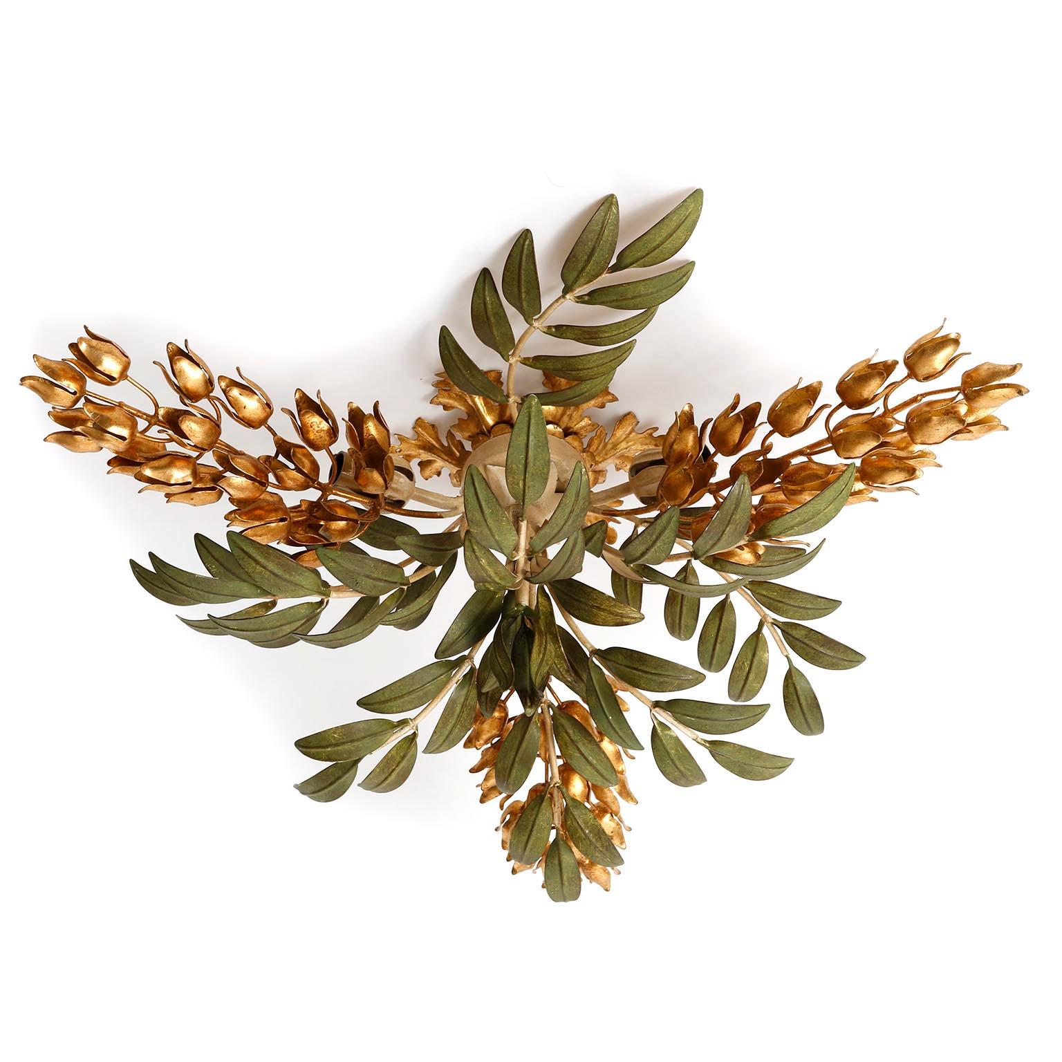 A Hollywood Regency flush mount light by Hans Kögl (Koegl or Kogl), Germany, manufactured in midcentury, circa 1970.
A beautiful light fixture featuring green leaves and golden blooms made of metal coated with gold leaf. The lamp has three sockets