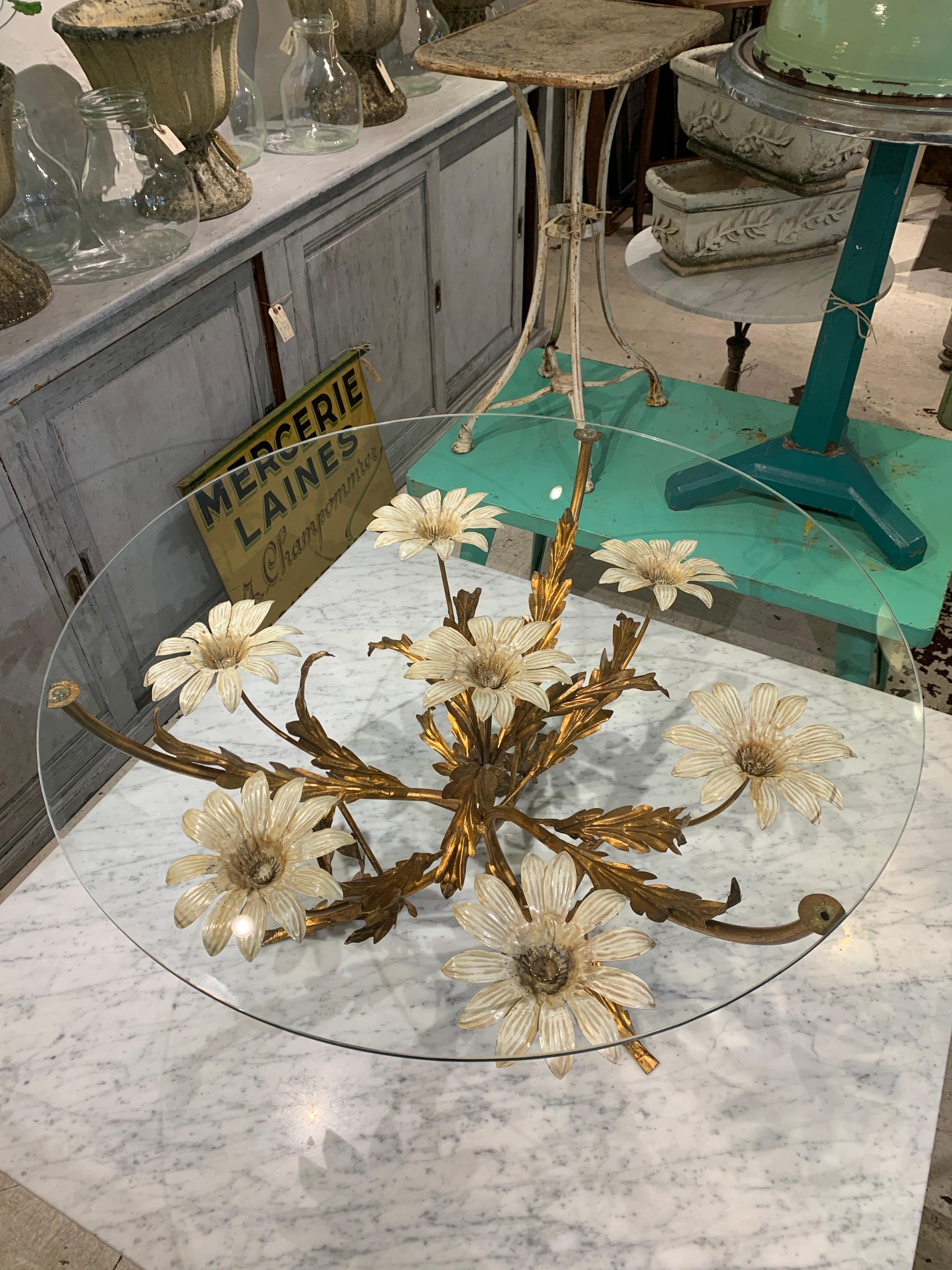 Much sought after and imaginatively stunning late midcentury coffee / side table, possibly early 1970’s. Created by well known German designer Hans Kögl. Sophisticated and elegantly designed, with a stunning gilded base, decorated with flower petals