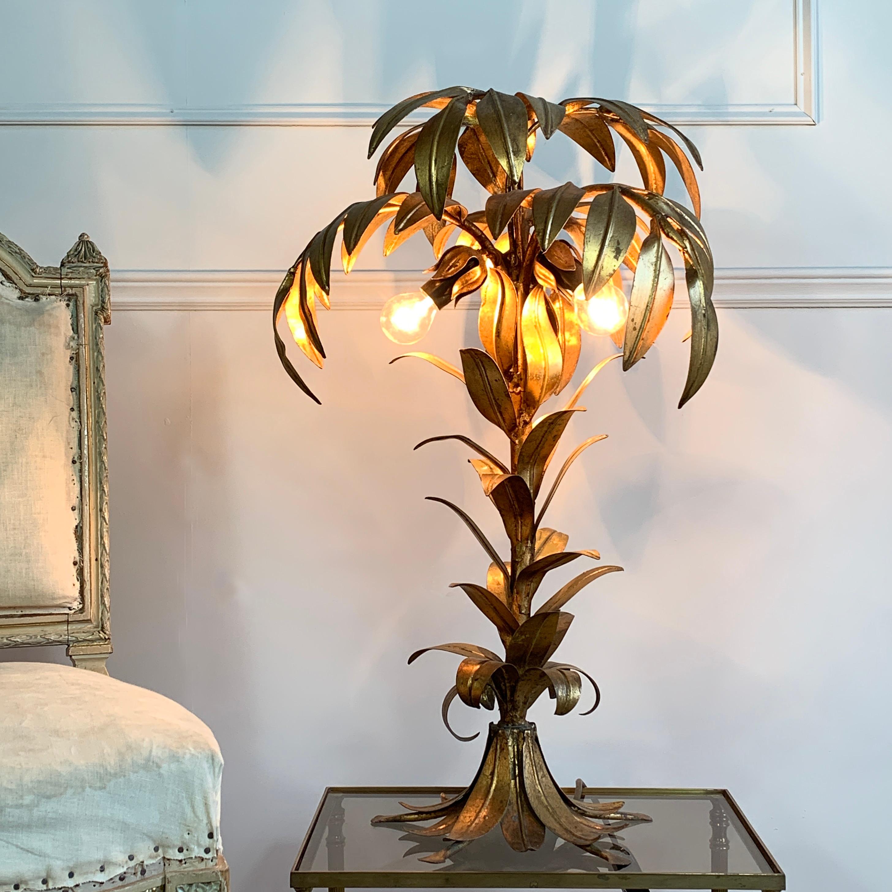 Stunning gilt metal palm tree lamp by Hans Kogl,  1970's Germany. Fronds of leaves arranged to form a beautiful gilt statement palm tree. This iconic palm tree lamp has 3 bulb holders hidden under the leaf canopy, taking e14 bulbs

Original gold