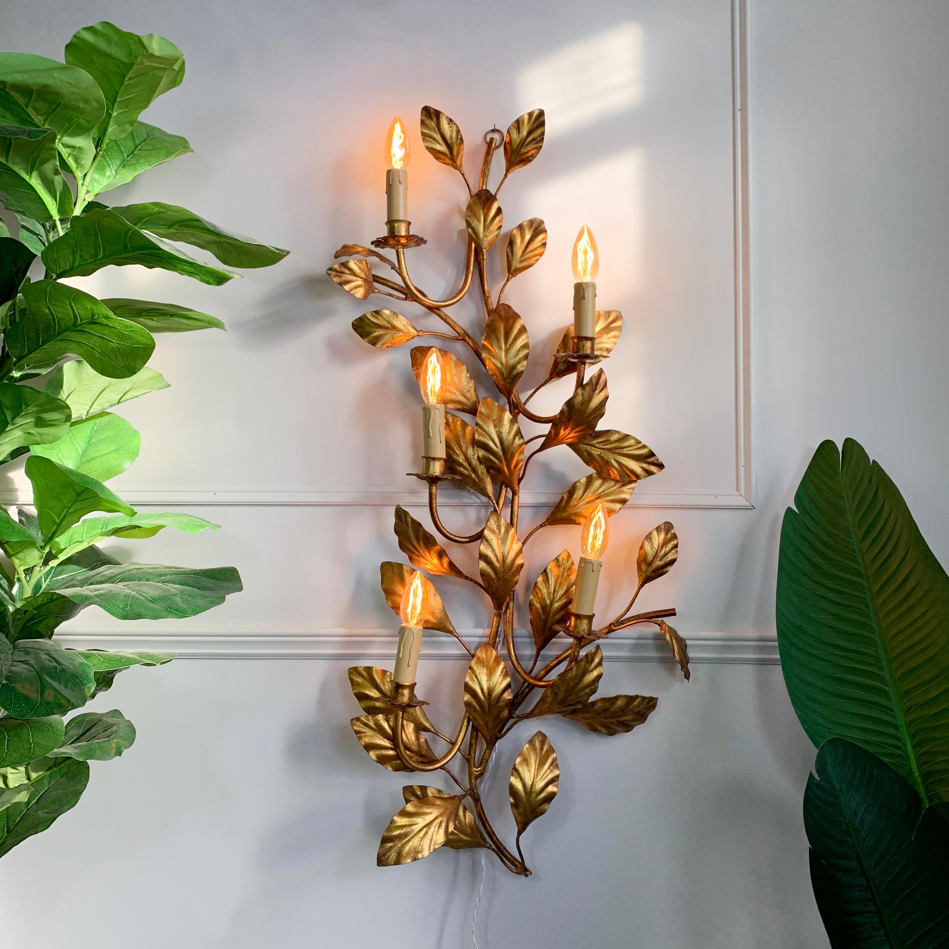 An incredible wall light by the German designer Hans Kogl, the branch and leaf design are entirely gilded, and the light is of very large proportions, with 5 e14 (small screw in) lamp holders. Such a beautiful piece, the design gives the light a