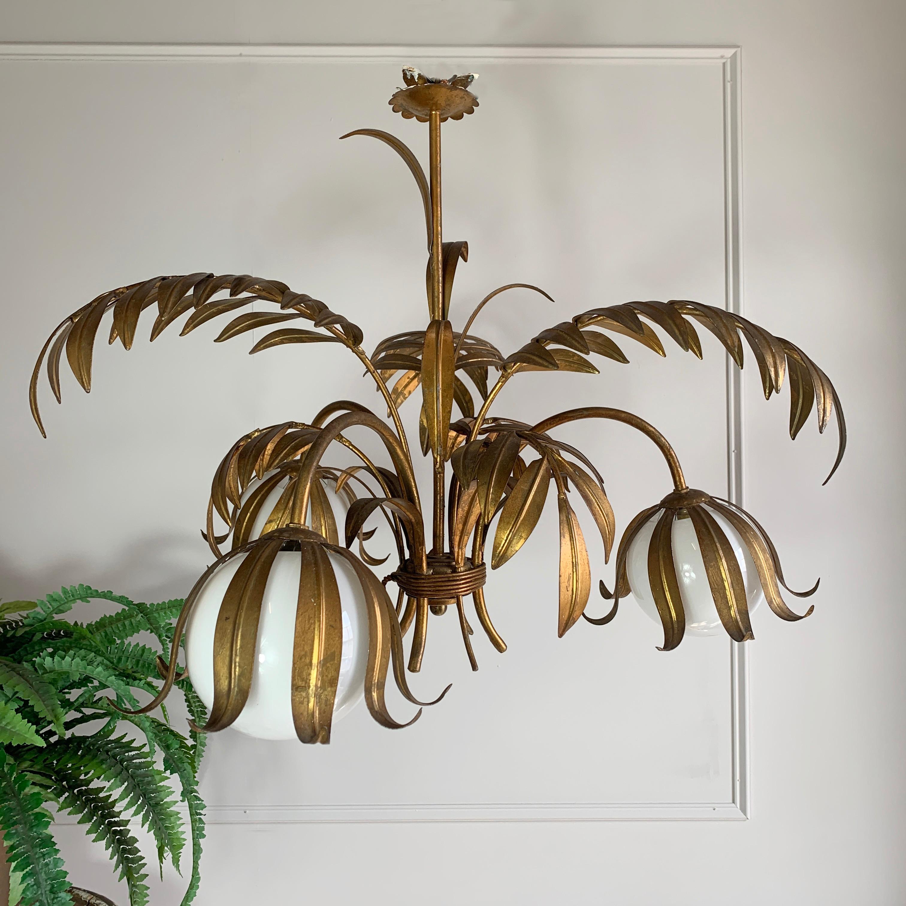 Hans Kogl palm leaf & globe chandelier, 1970’S
Fabulous Large Hans Kogl gilt palm leaf tole chandelier
1970'S, Belgium
Wide naturalistic palm leaves create the chandelier design
There are three arms holding a single bulb holder each
Three milk