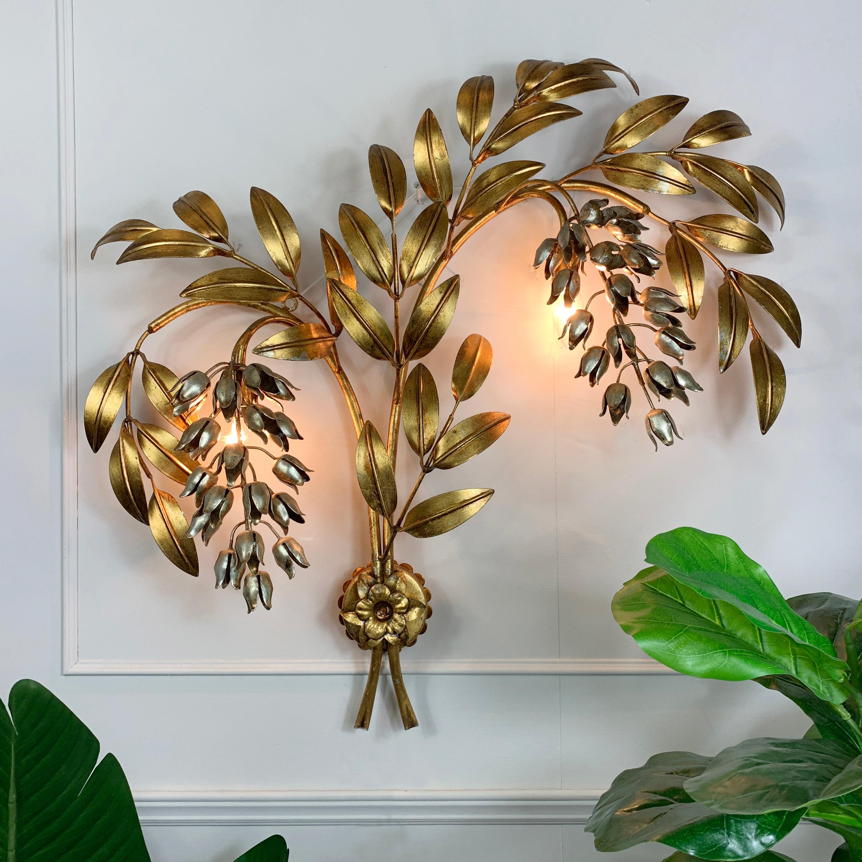 Monumental and impressive, original Hans Kogl Pioggia D'oro wall sconce

Large gold plated leaved branches with hanging silver wisteria flowers
by the world renowned designer Hans Kogl

The sconce takes 2 single e14 bulbs, hidden behind each of