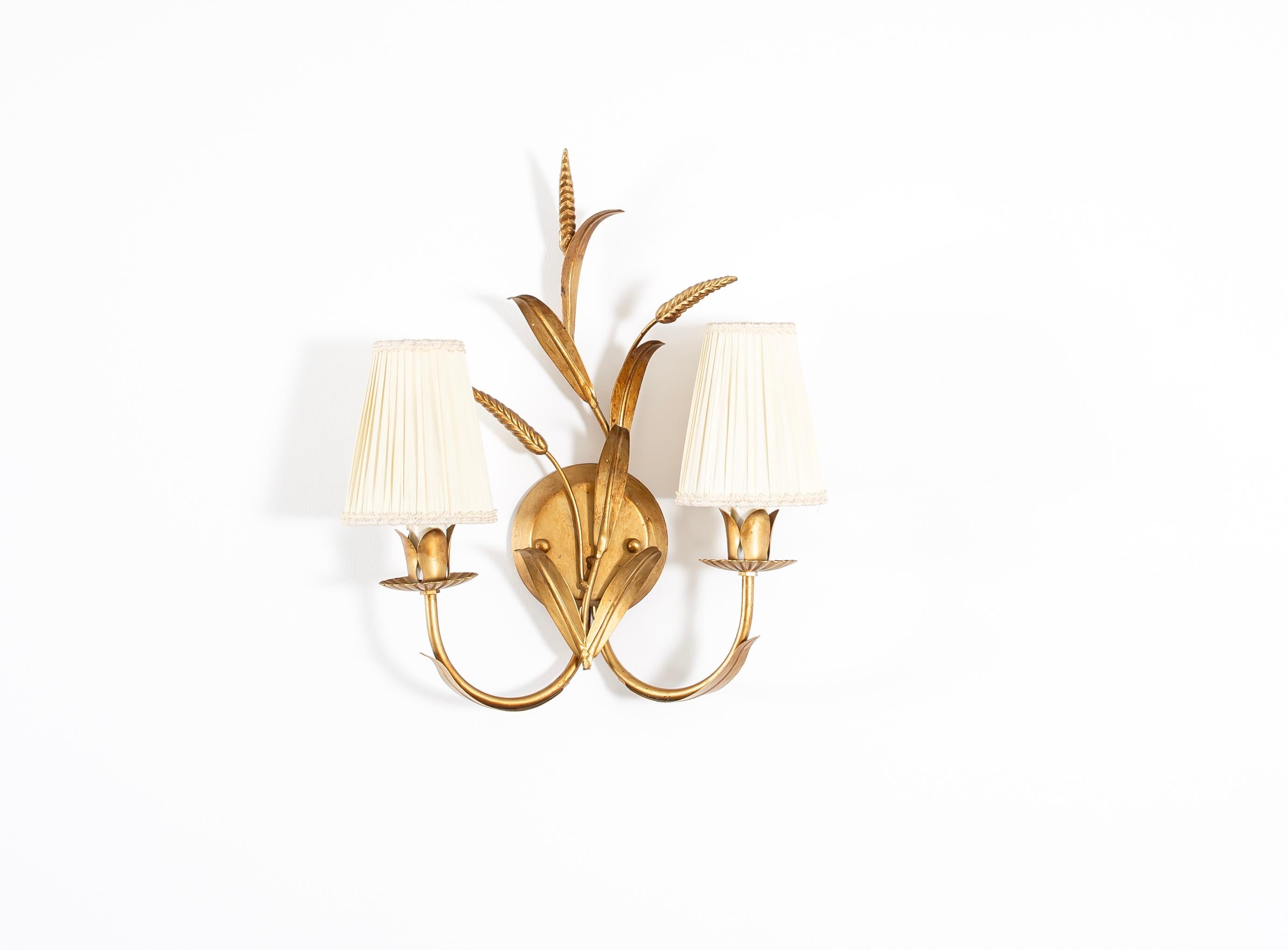 Sculptural and organically shaped wall light in gilded metal. Designed and made in Germany by Hans Kogl, famous for his large floor lights in brass. The lamp is fully working and in very good vintage condition. It is fitted with two E14 bulbs (works