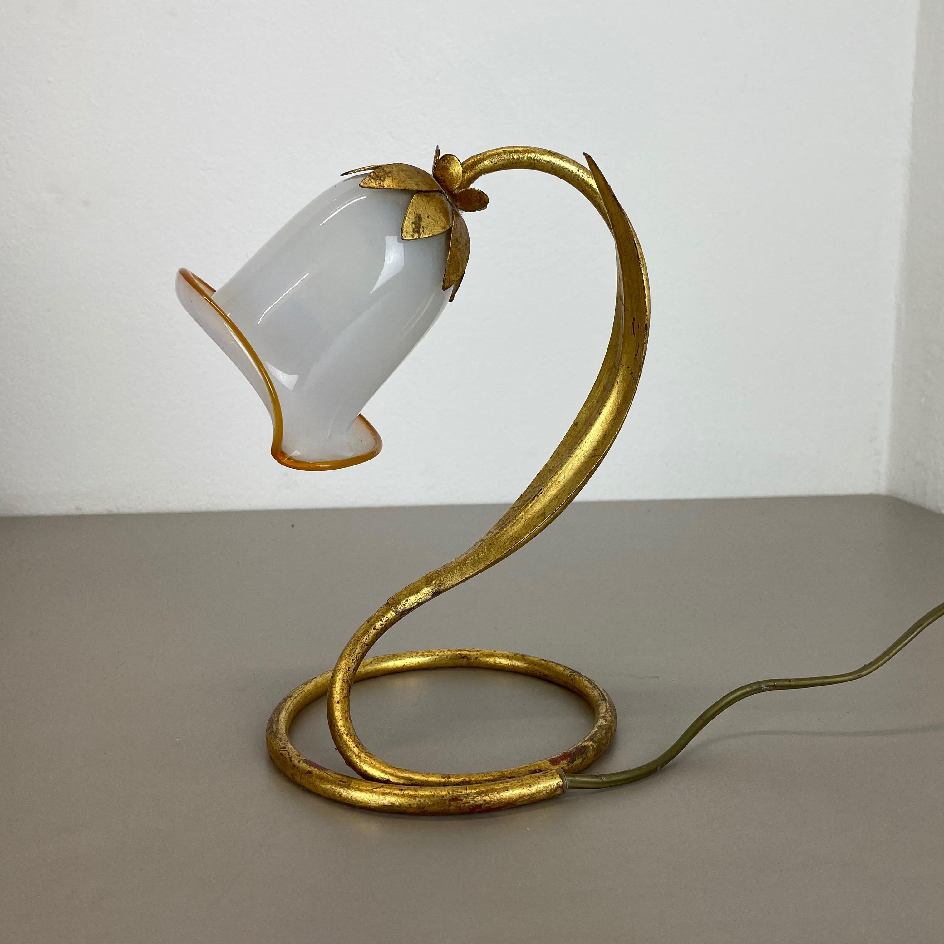 Article:

Table light with murano glass shade


Origin:

Italy



Age:

1970s.



This modernist light was produced in Italy in the 1970s . It is made from solid metal in form of a flower with blossom on the top with one socket