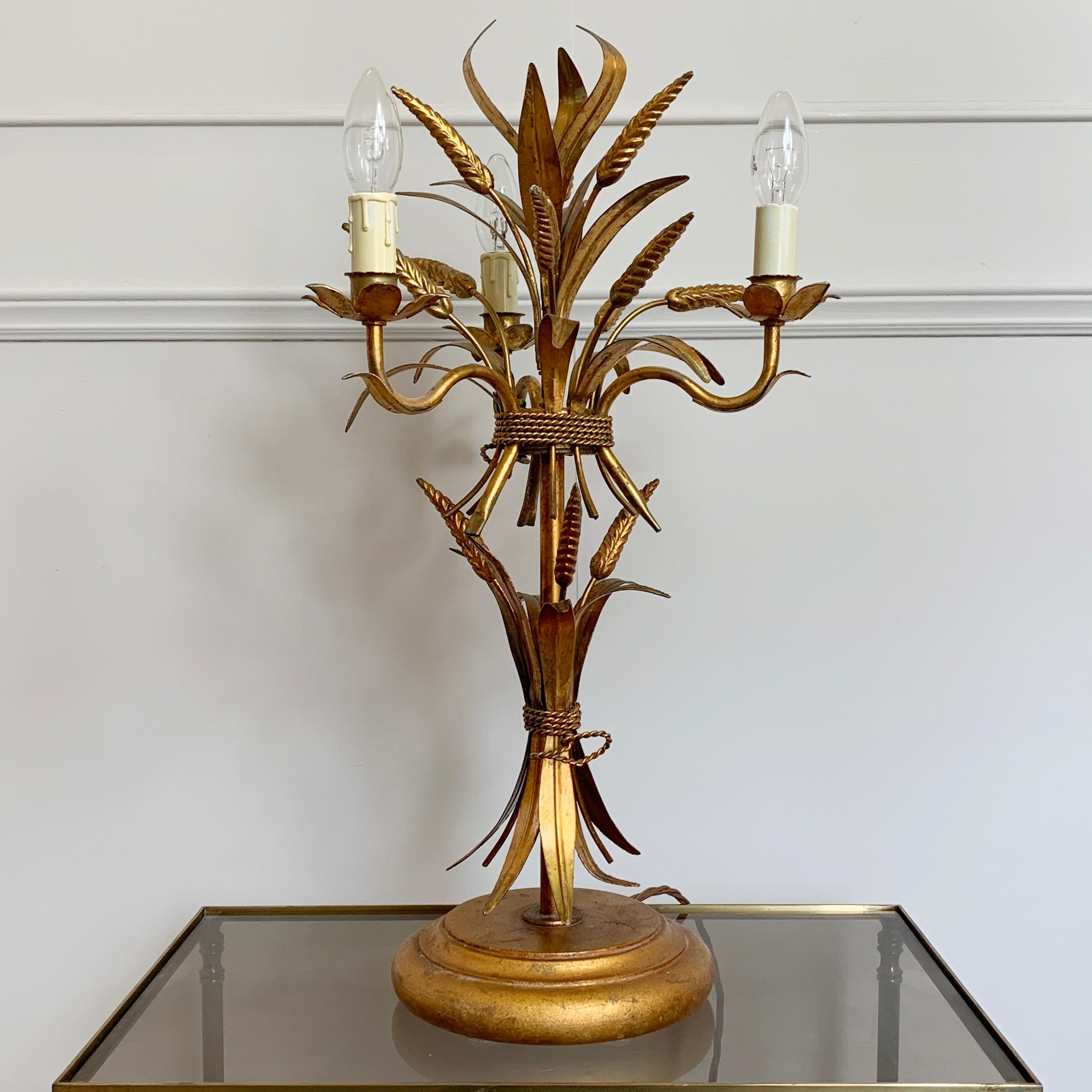 Hans Kögl wheat sheaf table lamp, circa 1970s
Statement wheatsheaf and gilt leaf lamp by Hans Kögl
Measures: 64cm height

There is a long lead with inline switch for ease of use
3 lamp holders with faux candle covers, e14 lamp holders

The lamp is