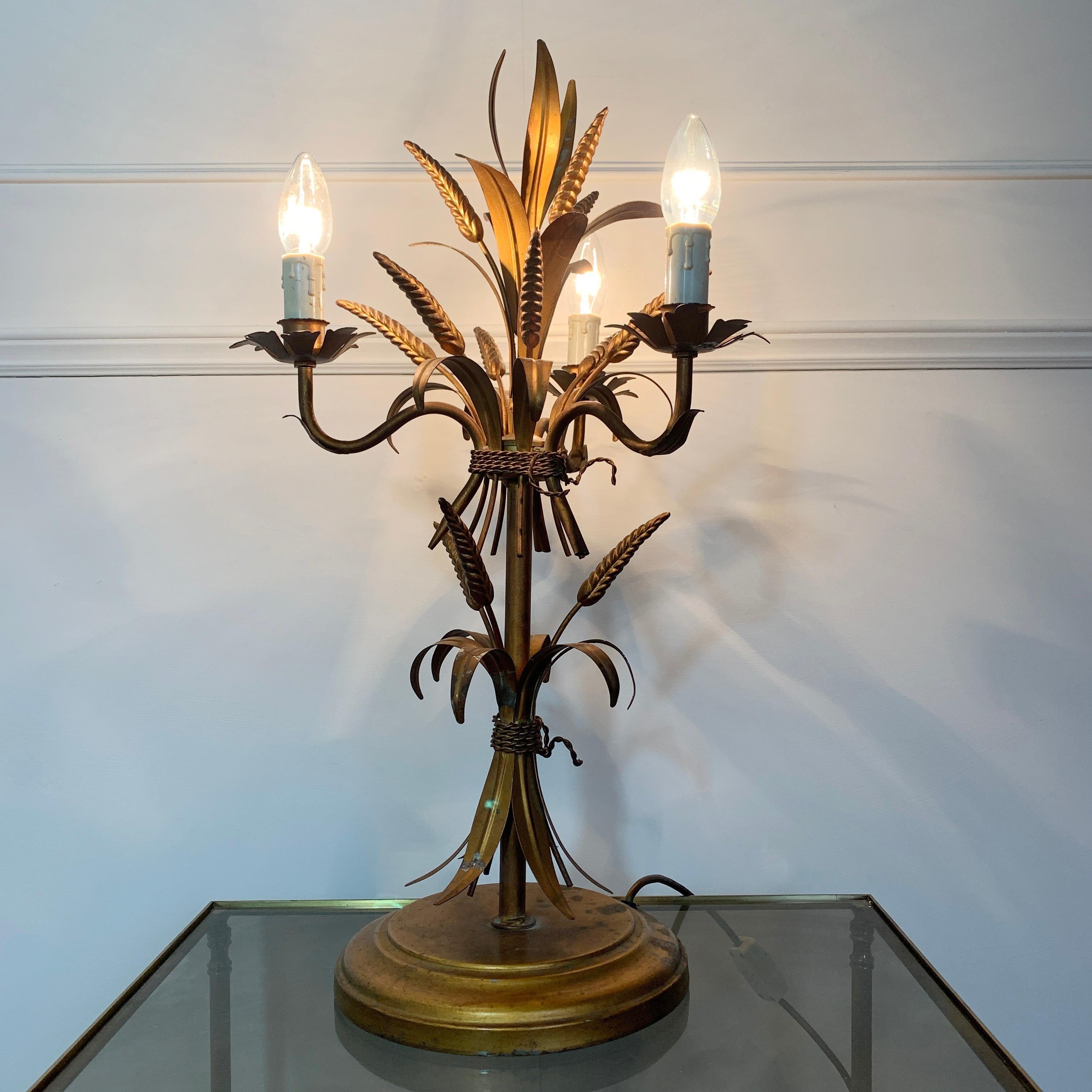 Hans Kögl wheat sheaf table lamp, circa 1970s
Statement Wheatsheaf and gilt leaf lamp by Hans Kögl

64cm height, 37cm width, base 25cm width

There is a long lead with inline switch for ease of use
3 lampholders with faux candle covers, e14 lamp