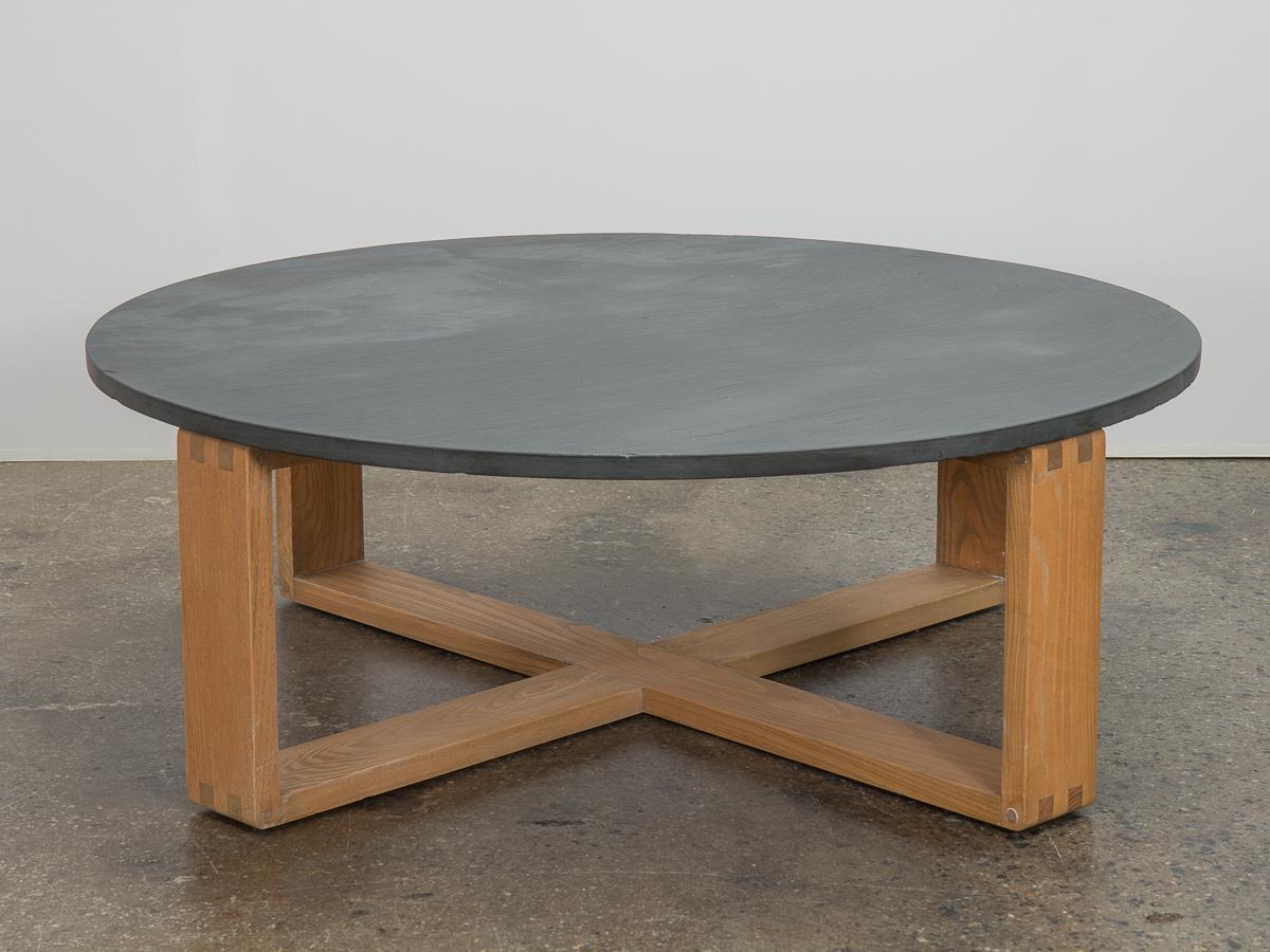 Substantial round slate-top coffee table on oak base, designed by Hans Krieks. Table features an impressive slate top is very thick, with a honed surface that exhibits the natural texture of the metamorphic rock. Sturdy oak base is well built with