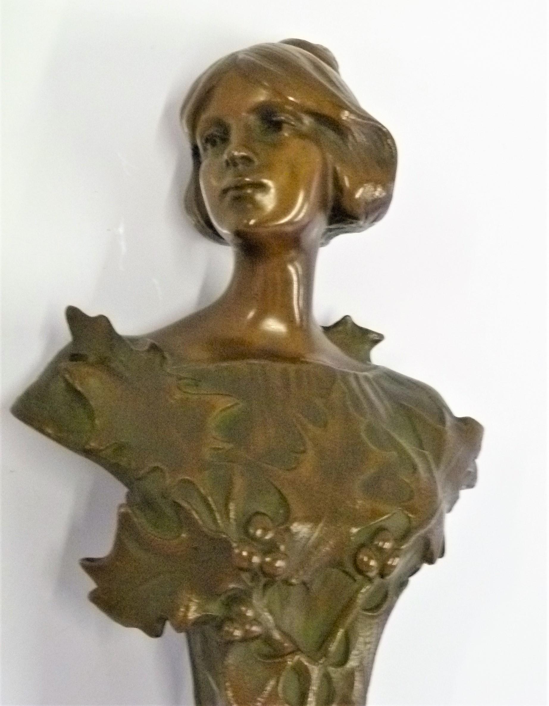 REDUCED FROM $950....Here you have a delicate and finely chased Jugenstil bust of a young lady with turn of the century upturned hair resting on a pedestal of what appears to be a vine of holly leaves and berries. Lovely period Art Nouveau form. The