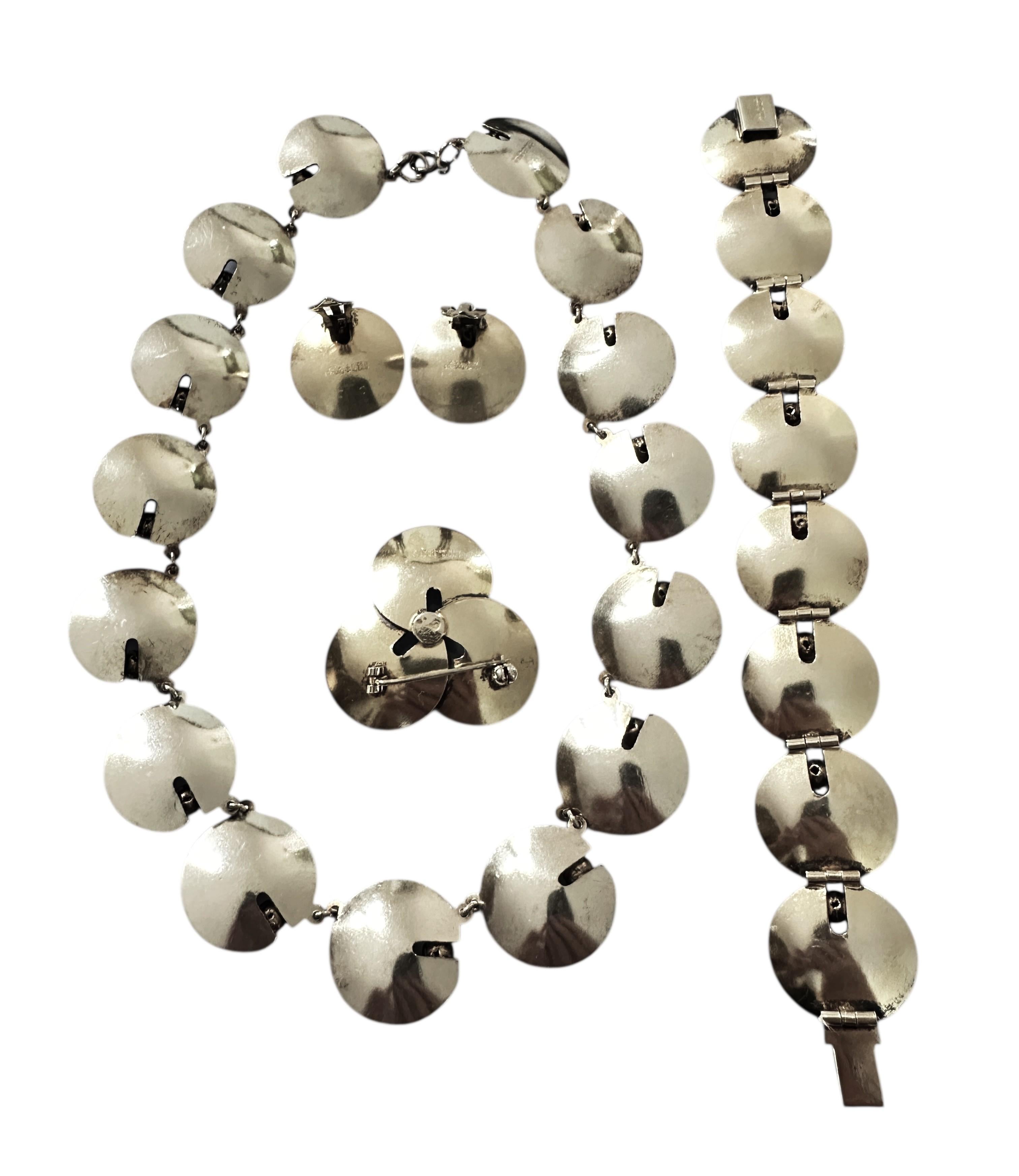 This Hans Myhre Modernist Norwegian Guilloche Enamel Silver Necklace Gilt Sterling Silver Suite including Necklace, Bracelet, Earrings, and Brooch.  The set is just gorgeous!  It is pre-owned but in excellent condition.  Very good care has been