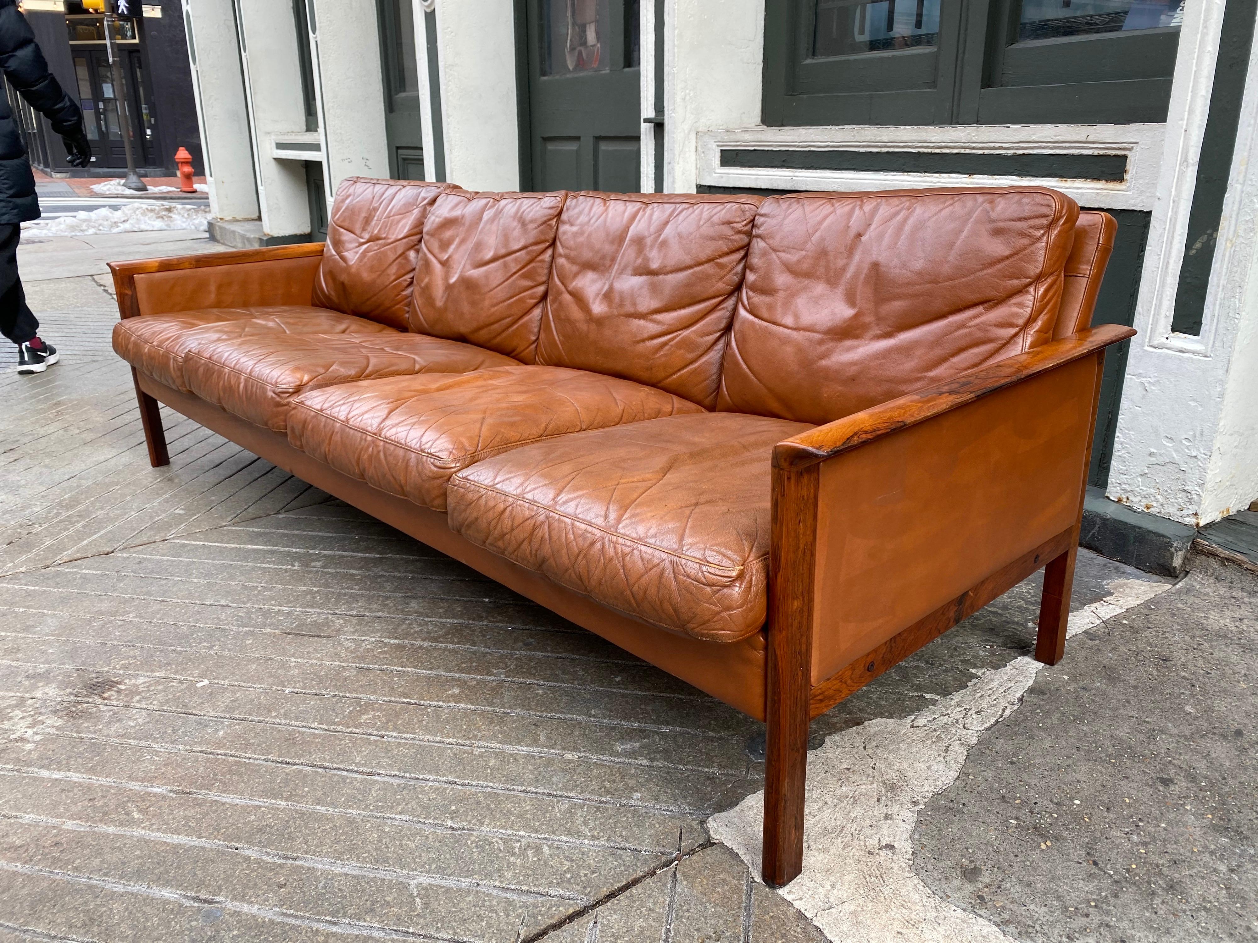 Hans Olsen and Knut Saeter for Vatne Møbler, Norway. Early 1960s rosewood and leather sofa. Leather is beautifully aged, shows signs of use and wear but amazing patina! Leather is super supple and soft! Rosewood shows a little fading, but very even.