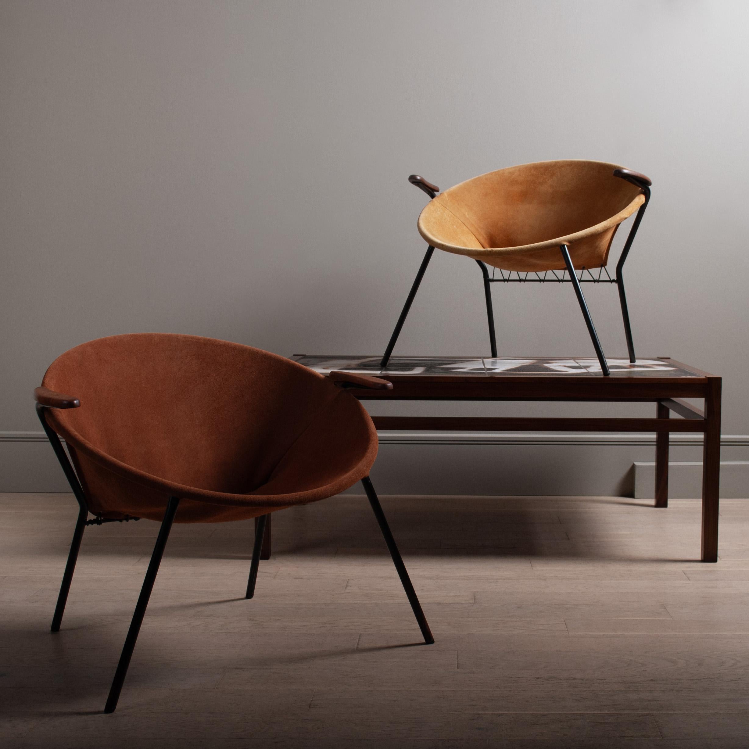 An early balloon or 'hoop' chair by Hans Olsen, circa 1955, Denmark.
All original leather suede upholstery on the circular metal frame with sweet little teak arms. A charming chair design by renowned designer Hans Olsen. A lighter tan version is