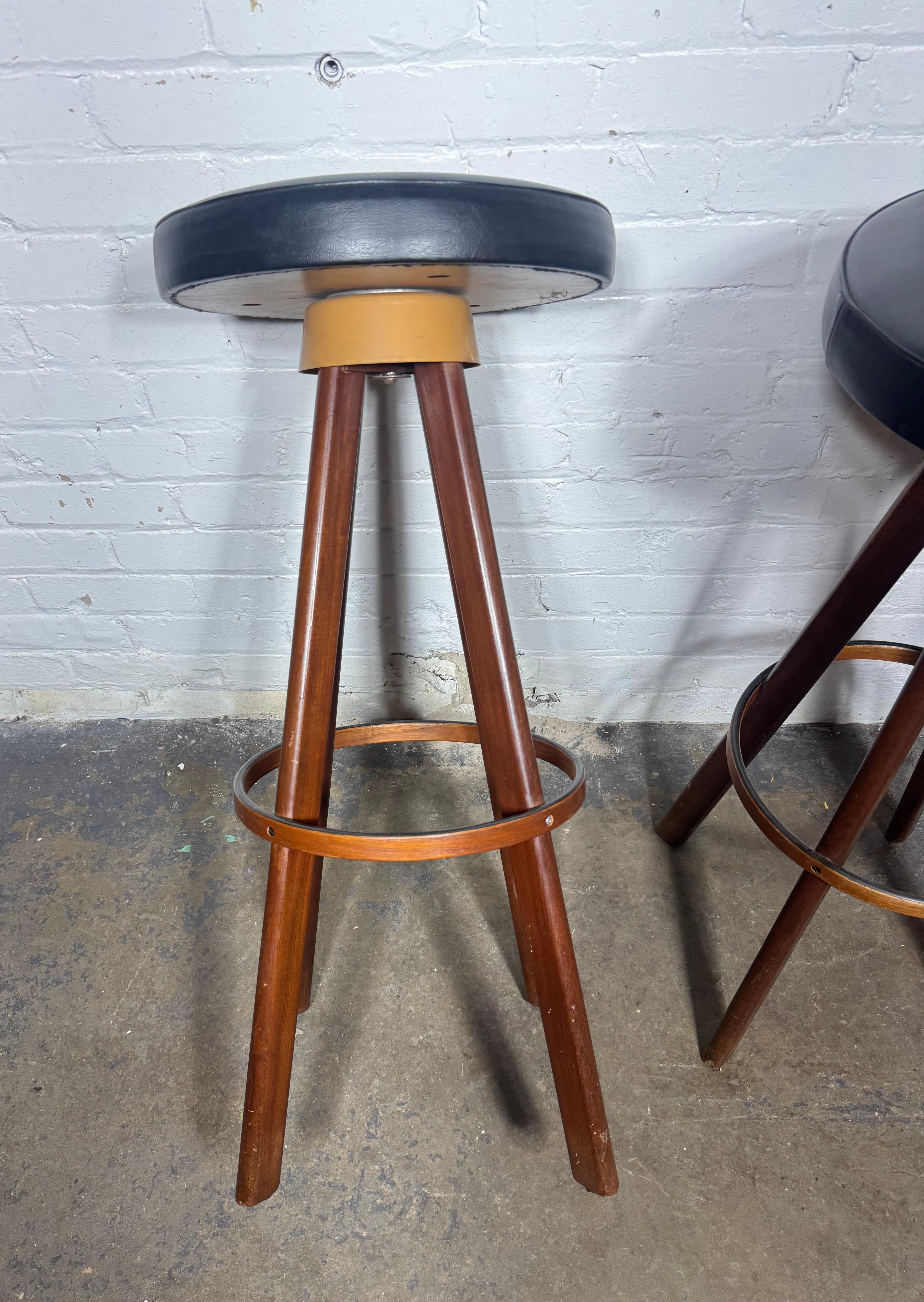 Très bel ensemble de 3 tabourets de bar conçus par Hans Olsen pour Frem Rojle, Danemark 1960.  base en bois de teck massif et sièges en similicuir noir pivotants. Très belle qualité et design simple et étonnant... Le siège est confortable et marqué