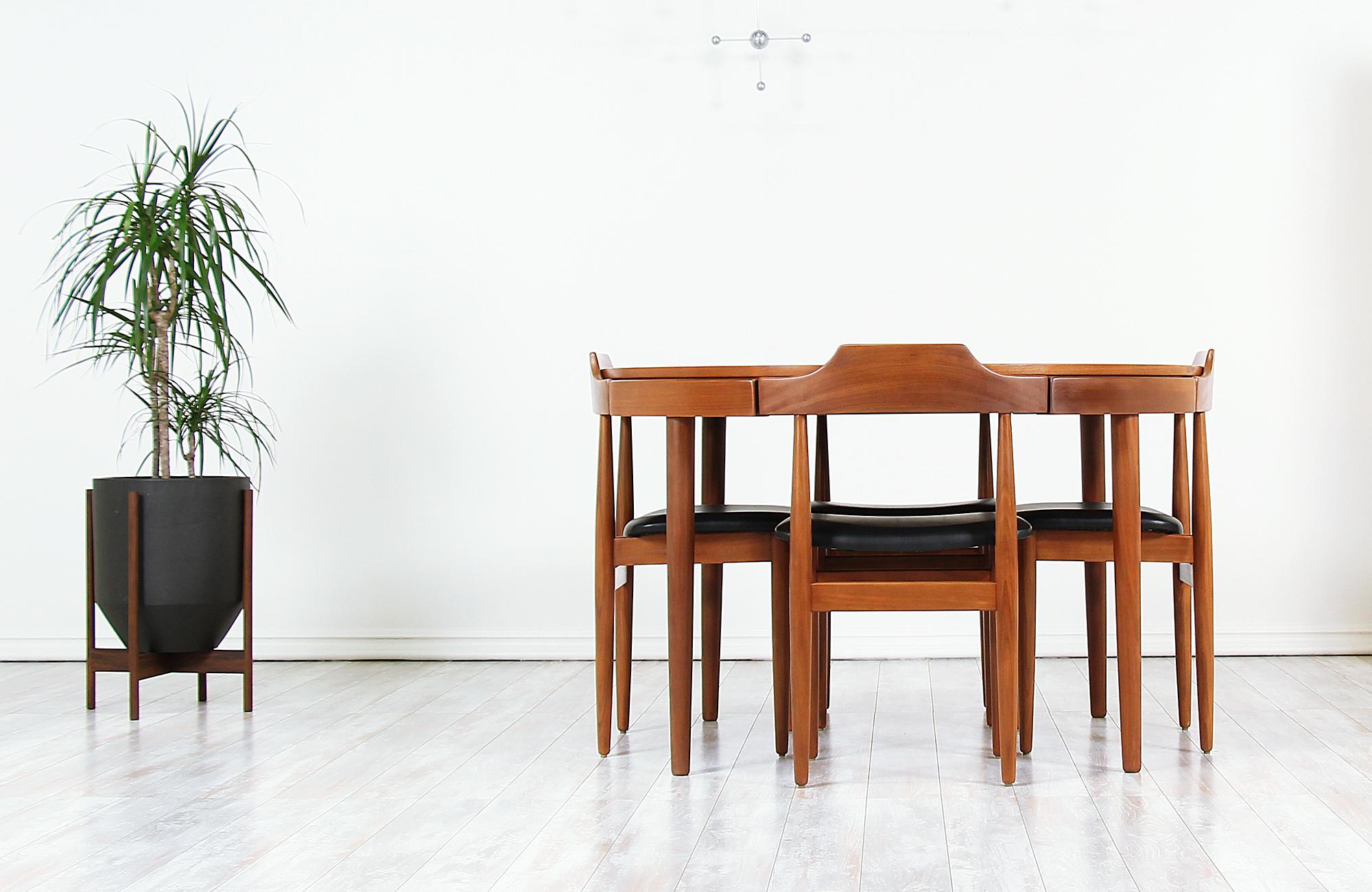 Rare dining set designed by Hans Olsen for Frem Rølje in Denmark, circa 1960s. This beautiful dining set features a sturdy teak wood frame with a butterfly-leaf extension to accommodate two more guests when needed. The extension leaf stores in the