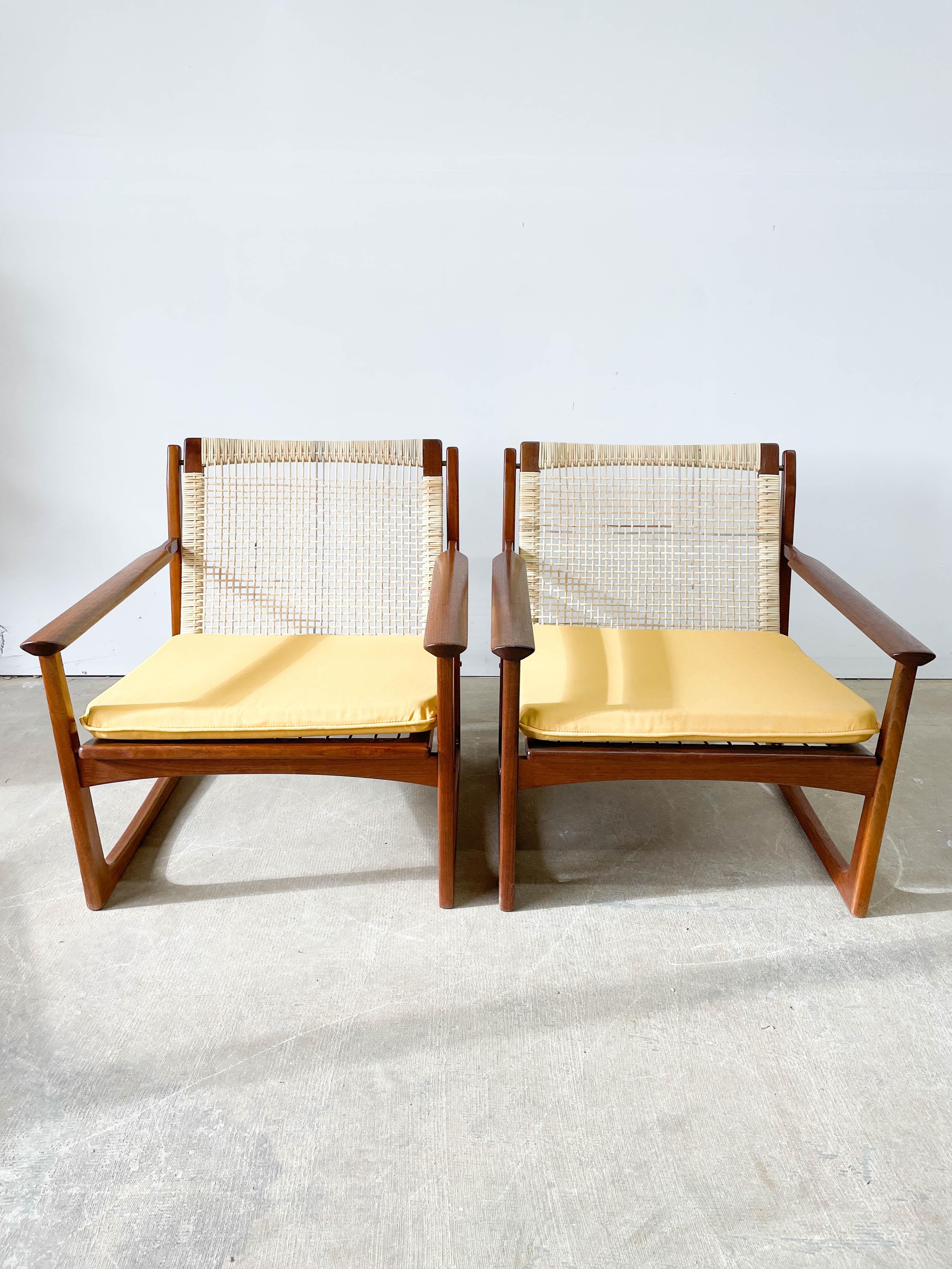 This is a superb pair of sled base lounge chairs with woven cane backs on teak frames. Designed by Hans Olsen and imported by Selig in the late 1950s, this is a fantastic example of Danish Modernism, combining craftsmanship, materials and style.