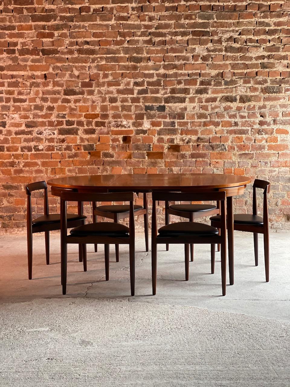 Midcentury Danish 'Dinette' extending dining table designed by Hans Olsen and manufactured by Frem Rojle in Denmark during the 1950s. The table is made from teak and features an extending mechanism complete with six chairs with original black vinyl