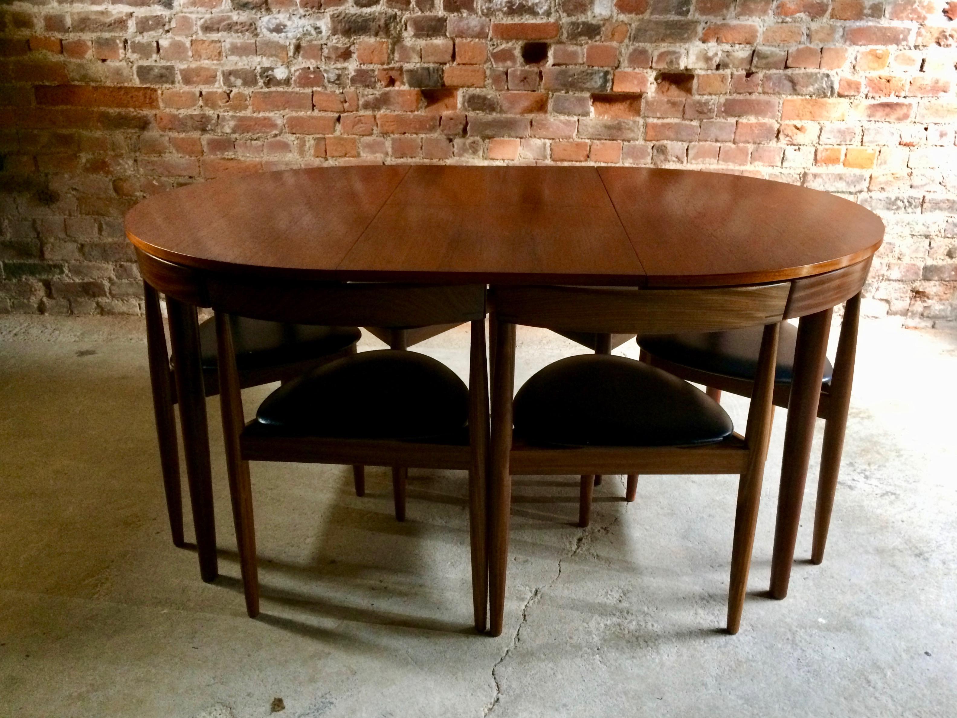 Magnificent midcentury 'Dinette' dining table designed by Hans Olsen and manufactured by Frem Rojle in Denmark during the 1950s. The table is made from teak and features an extending mechanism complete with six chairs (each chair with padded back