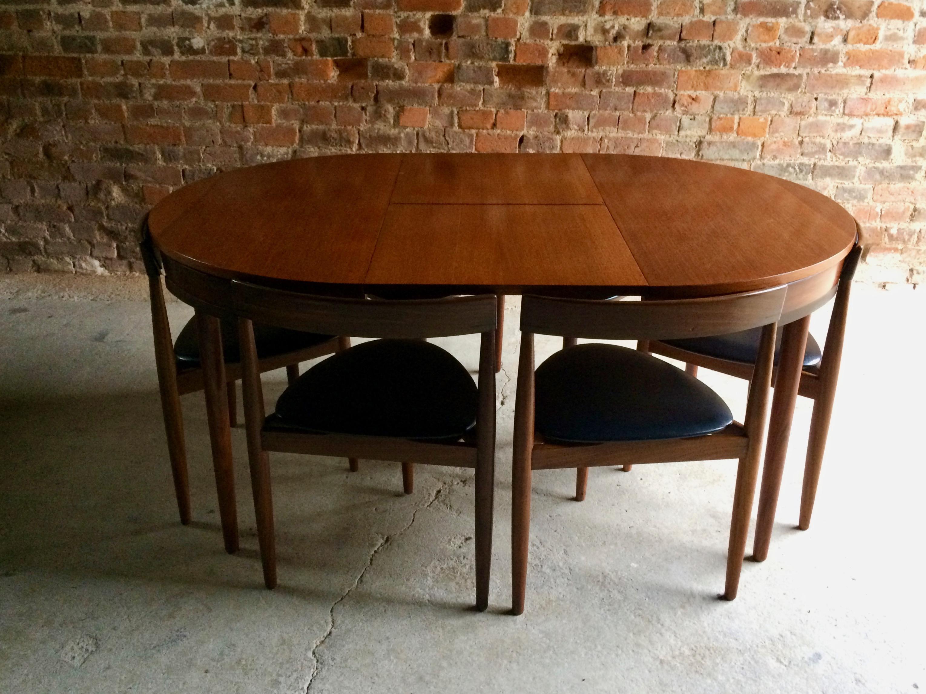 Magnificent midcentury 'Dinette' dining table designed by Hans Olsen and manufactured by Frem Rojle in Denmark during the 1950s. The table is made from teak and features an extending mechanism complete with six chairs (each chair with padded back