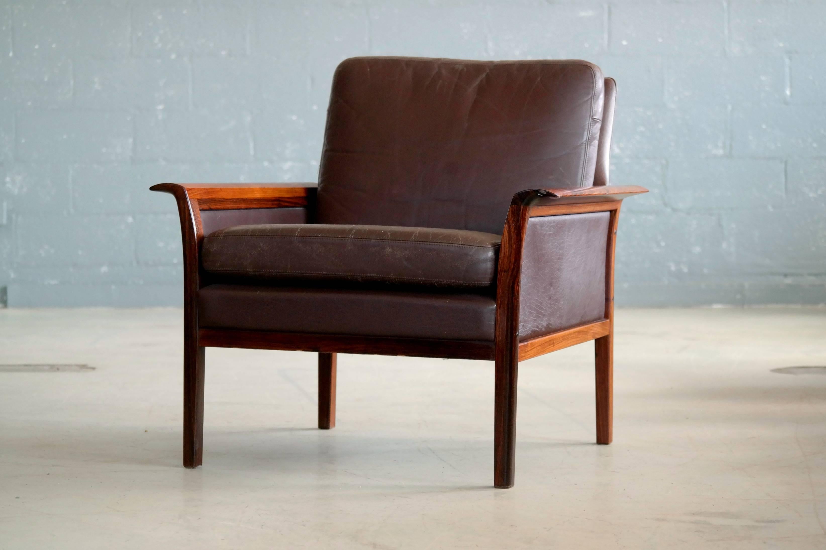 Beautiful Hans Olsen designed lounge chair in supple cordovan leather and rosewood frame manufactured by Vatne of Norway in the late 1960s. Olsen's characteristic design with finely polished rolled wing shaped armrests in solid rosewood. The