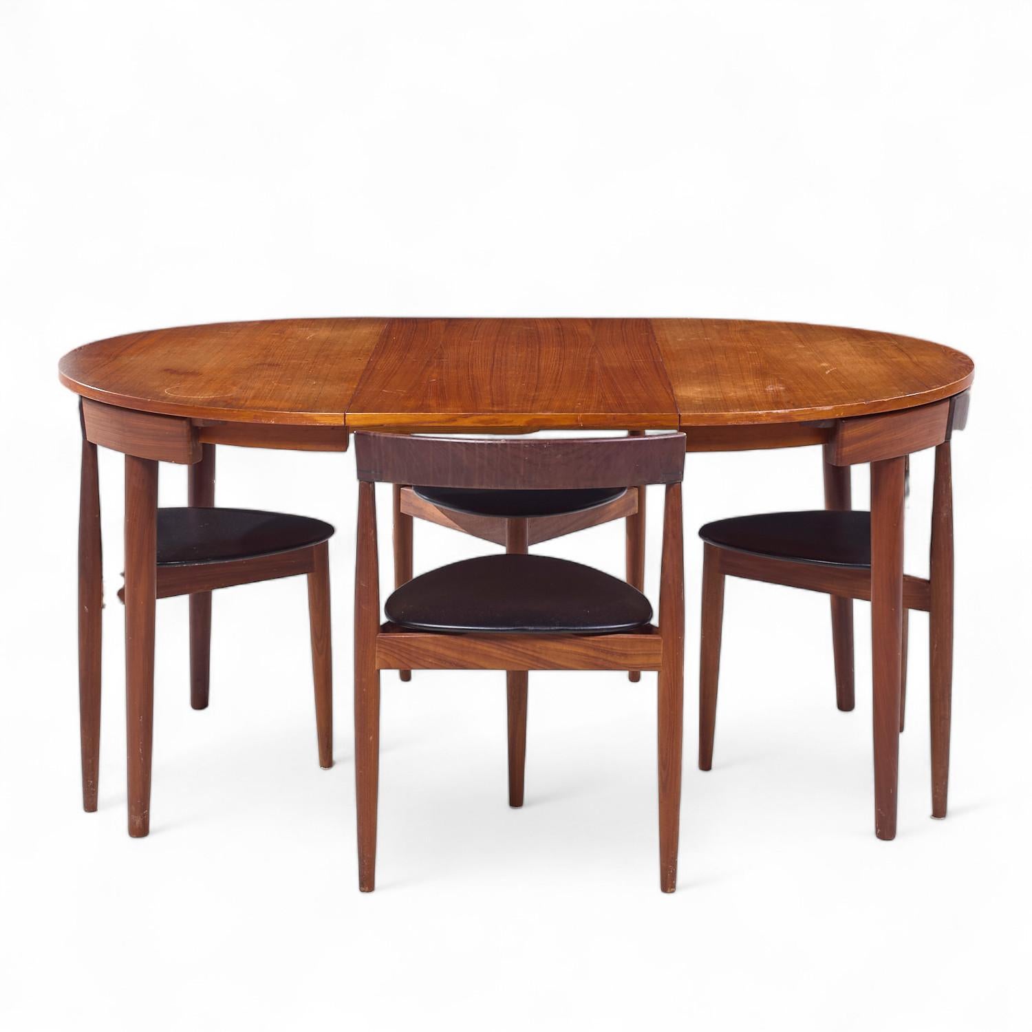 Hans Olsen for Frem Rojle Mid Century Expanding Teak Dining Table with 4 Nesting Chairs

The dining table measures: 41.75 wide x 41.75 deep x 29.25 high, with a chair clearance of 28.5 inches, the leaf measures 19.75 inches wide, making a maximum