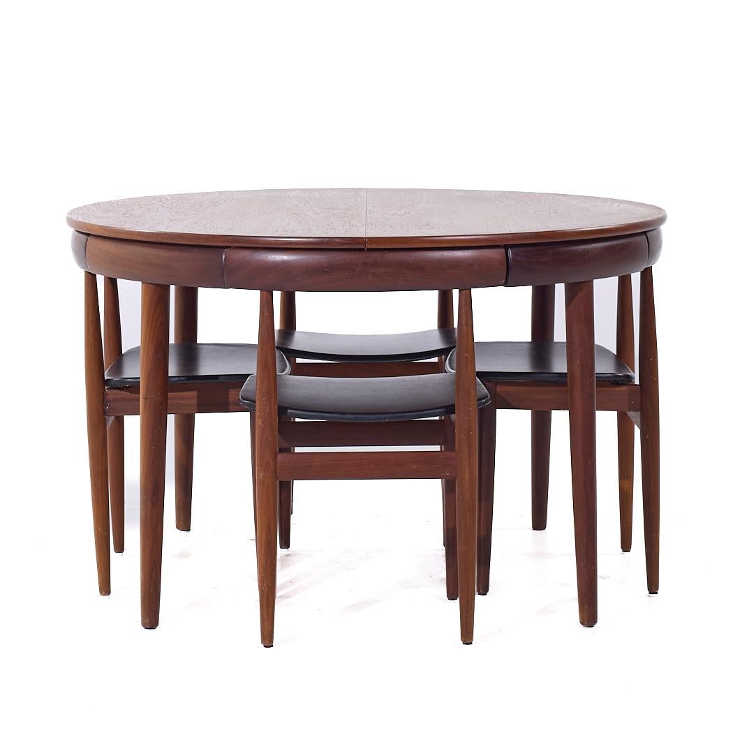 Hans Olsen for Frem Rojle Mid Century Expanding Teak Dining Table with 4 Nesting Chairs

The dining table measures: 41.5 wide x 41.5 deep x 28.75 high, with a chair clearance of 25.5 inches, the leaf measures 19.75 inches wide, making a maximum