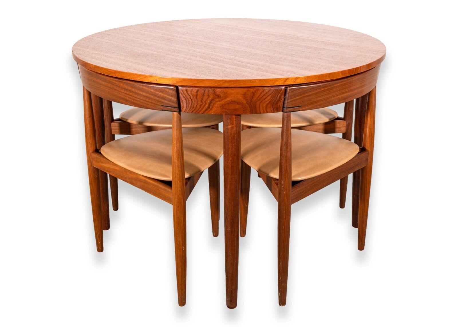 A Hans Olsen for Frem Rojle teak Danish dinette nesting game table and 4 chairs. A fantastic dinette set with classic Danish design. This set designed by Hans Olsen for Frem Rojle features a full teak wood construction, a circular table top, and a