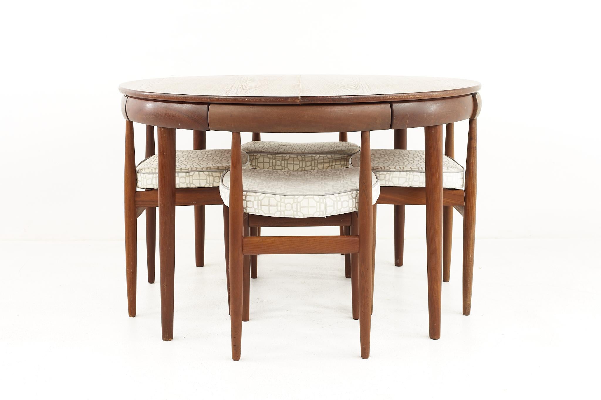 Hans Olsen for Frem Rojle Mid Century Teak Dining Table with Nesting Chairs - Set of 4

The table measures: 47 wide x 47 deep x 29.25 high, with a chair clearance of 26.5 inches; the leaf is 20 inches wide, making a maximum table width of 67