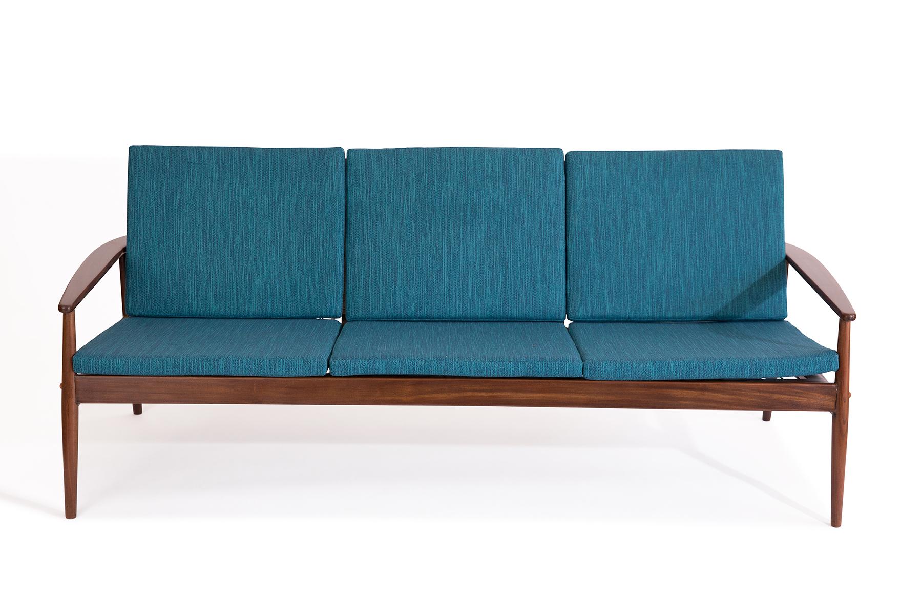 Hans Olsen for Juul Kristensen solid teak cane and upholstered sofa, circa early 1960s. This stunning example has been newly finished, upholstered and recaned.