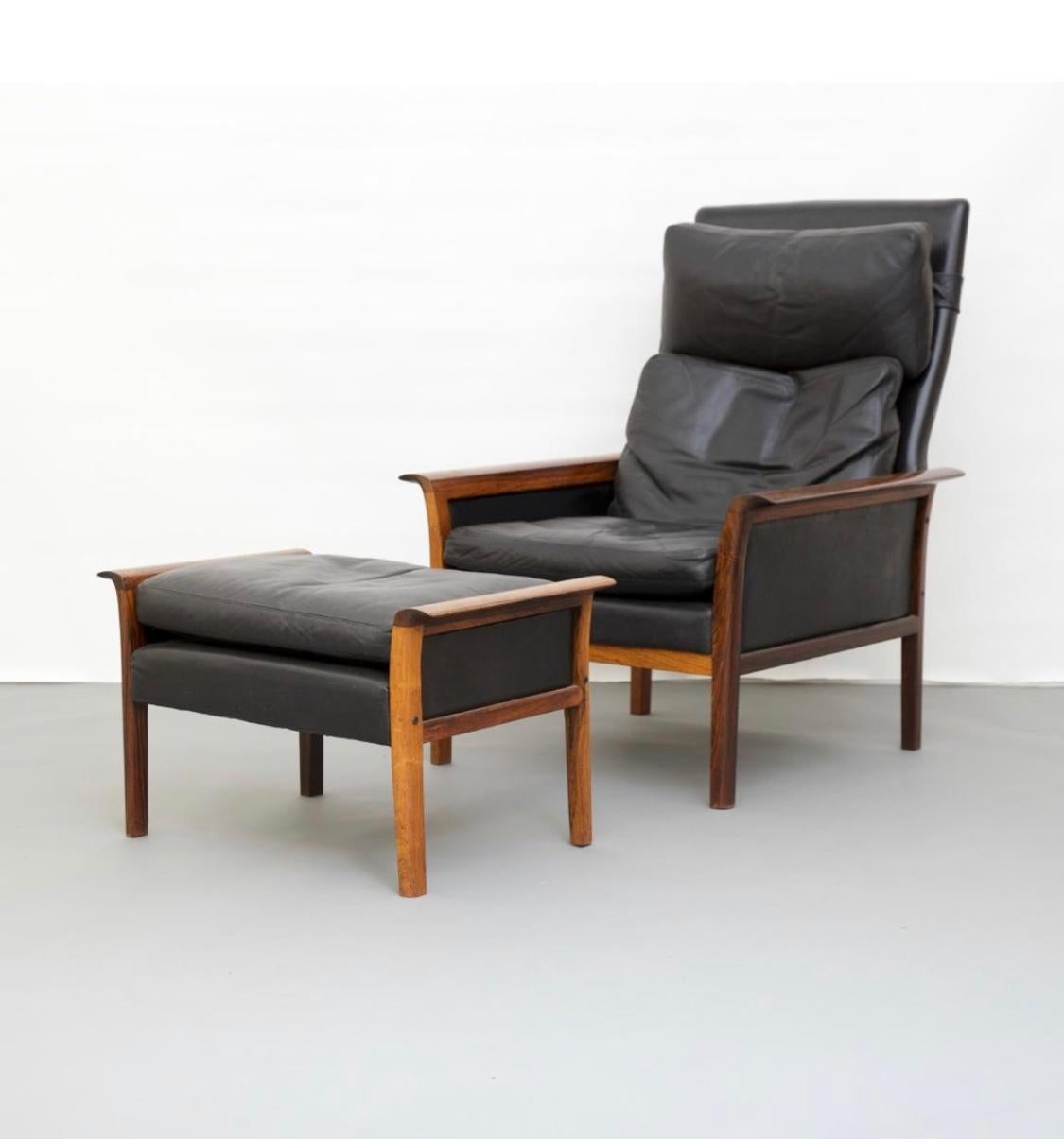 Hans Olsen (1919-1992) for Vatne Mobler, Norway. Mid-Century Modern high back lounge chair and ottoman, designed 1965. Black leather and rolled winged edge rosewood arms. Metal tag on the underside of both reads 
