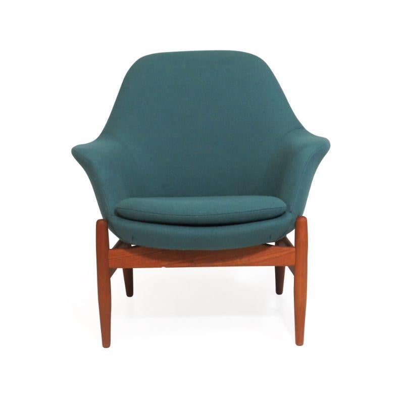 Mid-century lounge chair designed by Hans Olsen, circa 1959. Chair crafted of a solid teak frame, sculpted armrests, and blue green wool upholstery over natural latex foam and raised on solid tapered legs floating frame. Chair is fully restored by