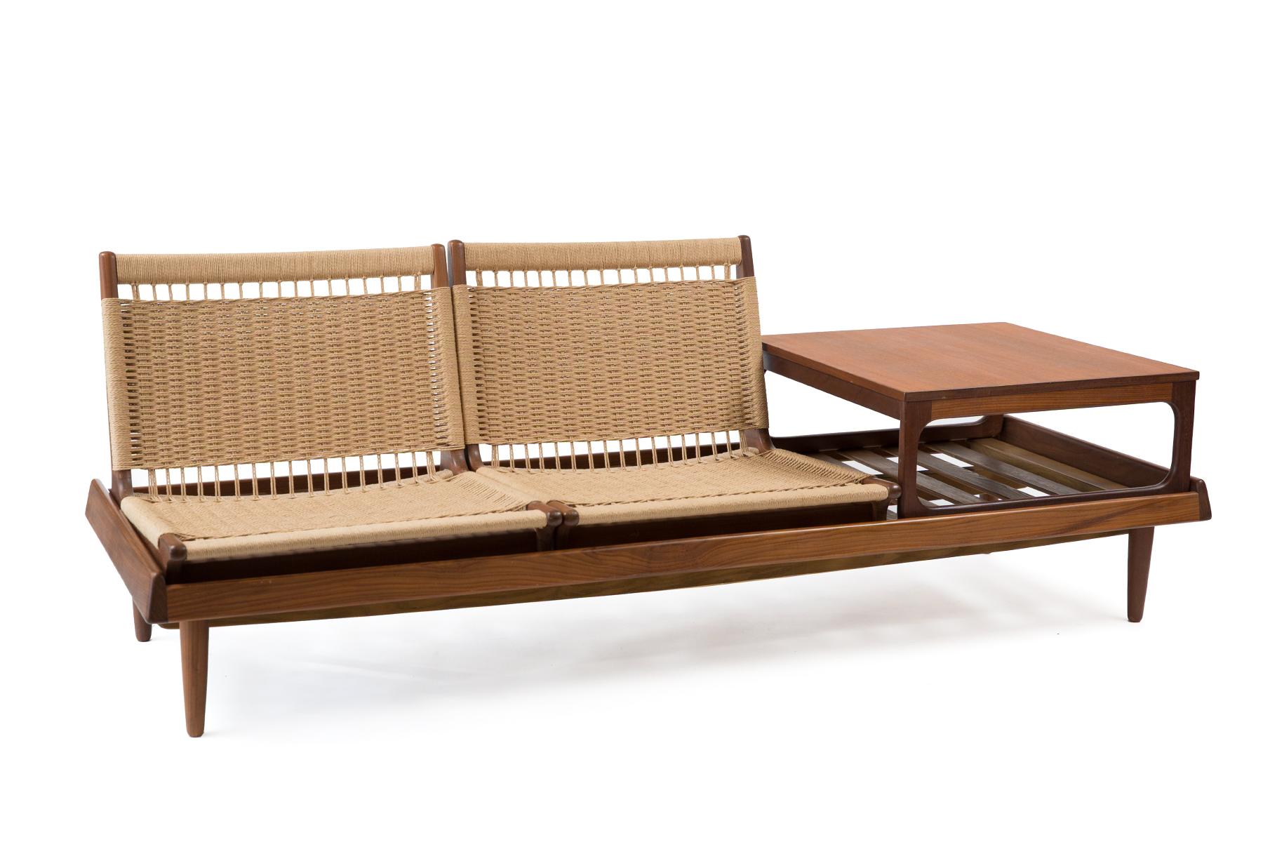 This rare Hans Olsen for Bramin modular seating is from the early 1960s. The set's versatility is showcased with two low woven chairs and a table that sit atop a stunning bench. The chairs and table are removable so that they can be placed in