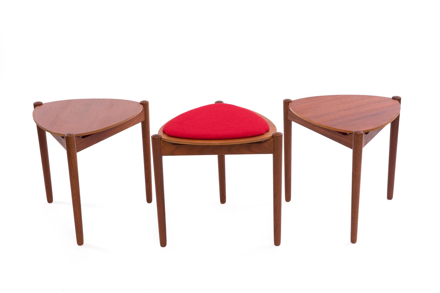 A set of 3 handsome Danish teak side tables by Hans Olsen for Bramin featuring unique reversible table-tops. Choose the teak side or the bright red woolen side for a pop of color in your home. The set still retains their original Bramin labels.