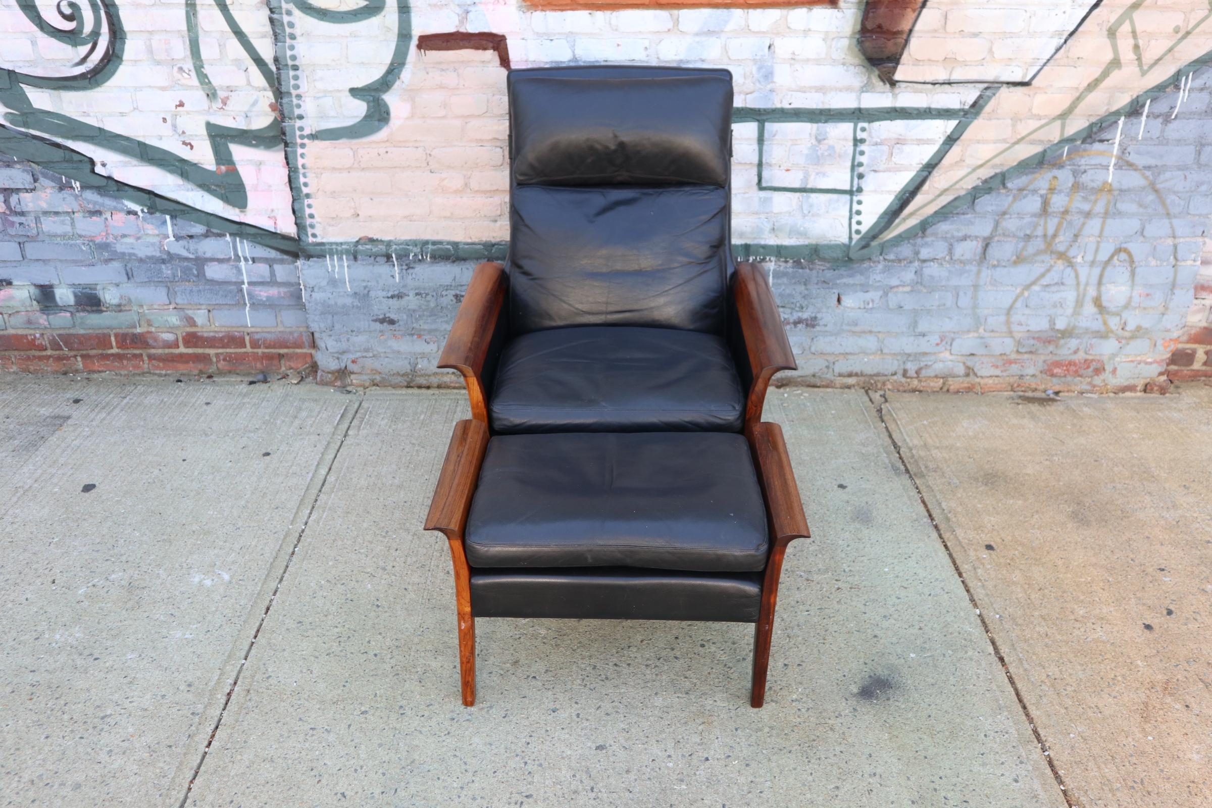 Elegant leather lounge chair and ottoman designed by Hans Olsen for Varner Mobler. Original upholstery accented by rich rosewood arms and legs. Deep color and perfectly aged leather combine for comfort in style. Manufacturer’s label to the underside.