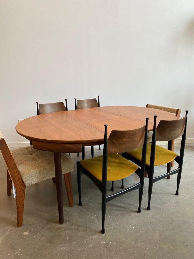 Hans Olsen round teak dining table manufactured by Frem Rølje. This table has an inner leaf that folds out to perfectly accommodate six chairs. Stamped on the bottom surface.