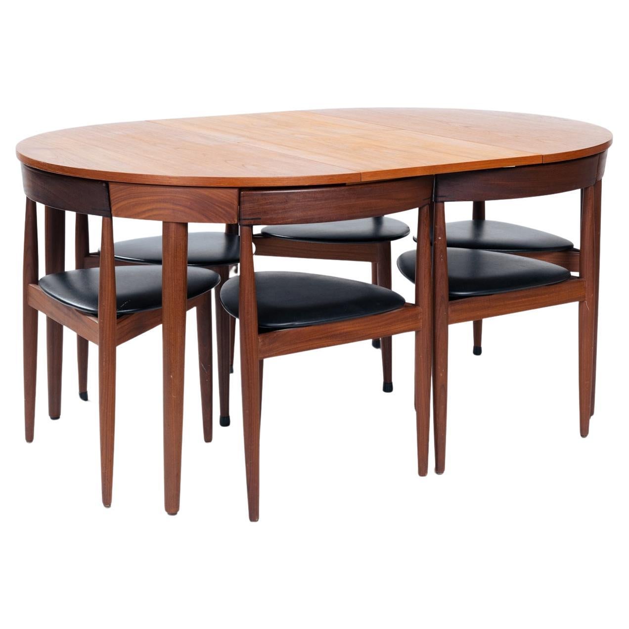 Round or oval? Its your call! 
Danish Mid Century Hans Olsen Roundette space saving extending teak dining table with 6 chairs by Frem Røjle. 

Originally designed by Hans Olsen in 1952 for Frem Røjle this dining set has since become an icon of