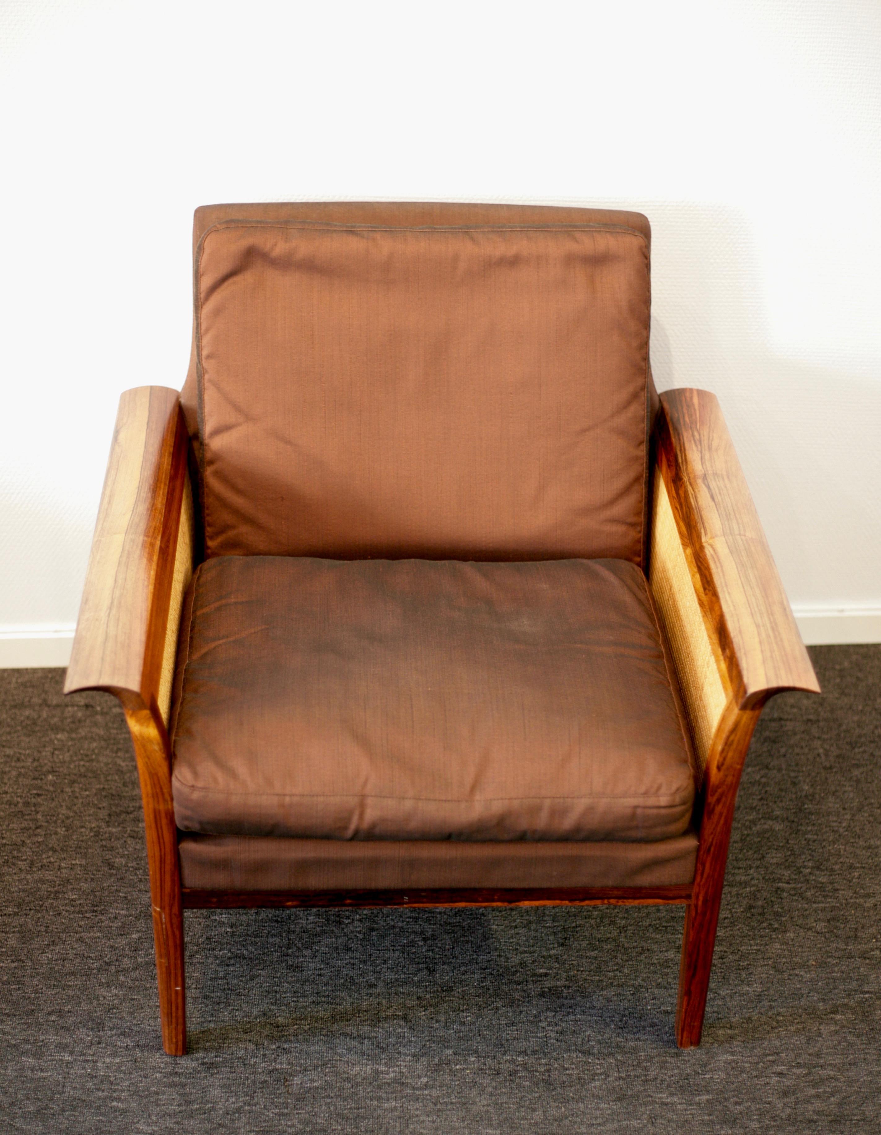 2 easy chairs designed by Hans Olsen for Vatne in Norway. Solid rosewood and rattan. Upholstery in a stylish copper colored Thai silk. Rattan without damages and normal wear to wood. Upholstery in good condition. New cushions. Cites certificate
