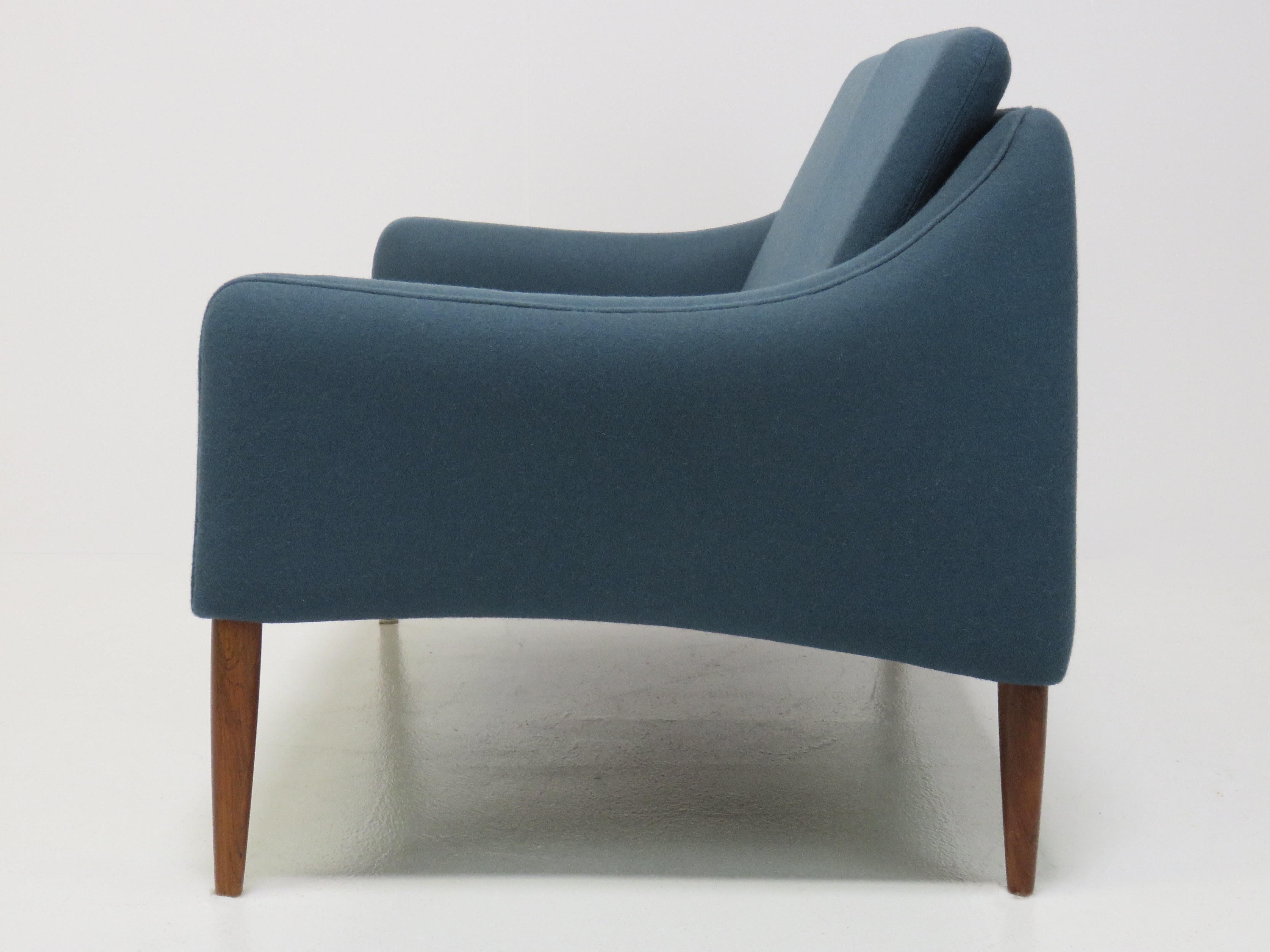 A rare settee model 800/2 by Hans Olsen for CS Mobler. The settee is reupholstered in a vintage powder teal wool fabric. Tapered teak legs.