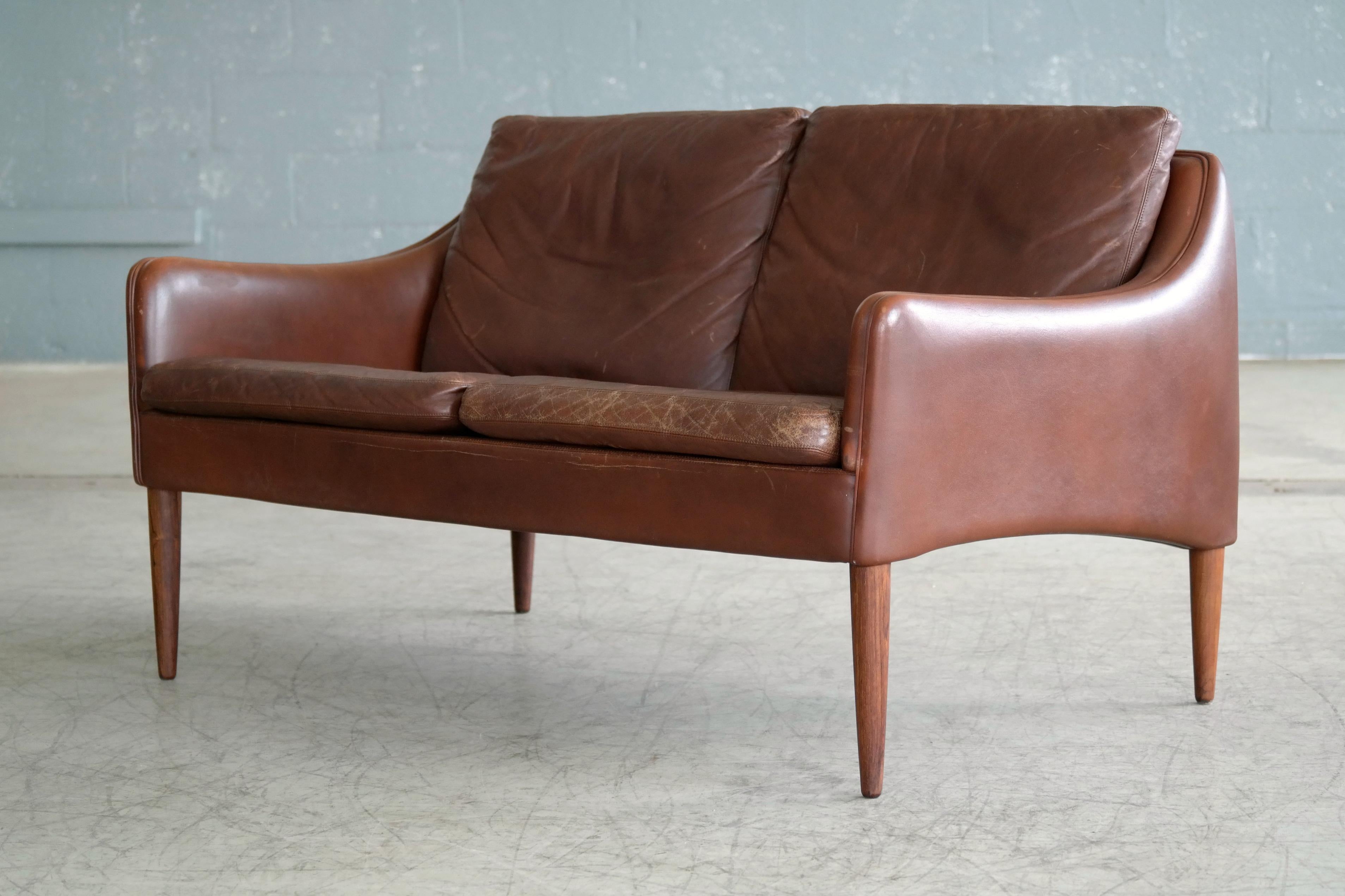 Rare and stunning settee or two-seat sofa designed by Hans Olsen in 1966 for CS Mobler of Glostrup right outside Copenhagen. Beautiful and sensuous design and arguably Hans Olsen's most beautiful sofa. Upholstered in warm medium brown colored