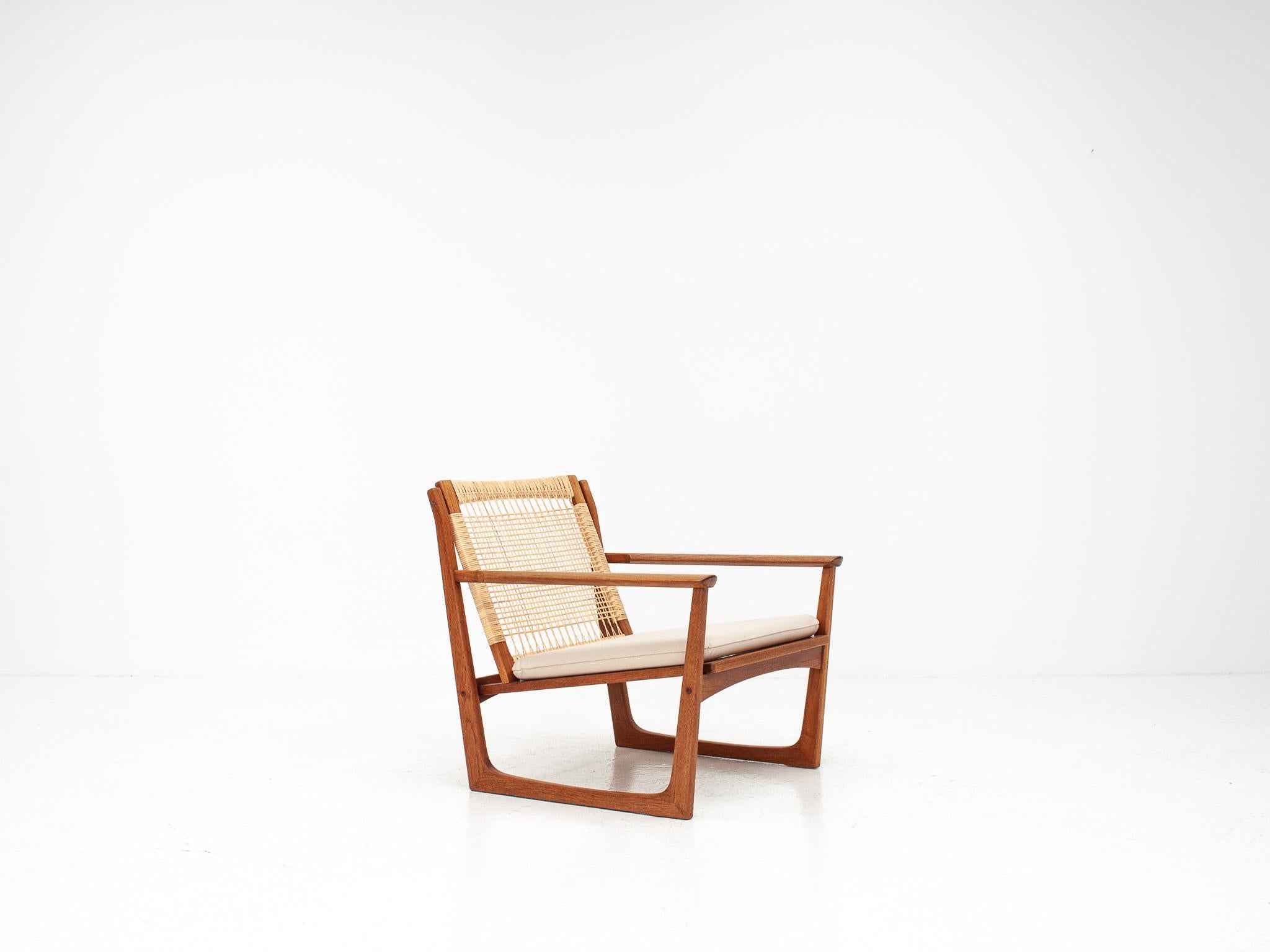 A Hans Olsen sledge based easy chair in teak, cane and brass, produced by 
Juul Kristensen, Denmark, in the late 1950s/early 1960s.
 
The condition is very nice, sturdy, with only light signs of wear and at some 
point in its recent past the