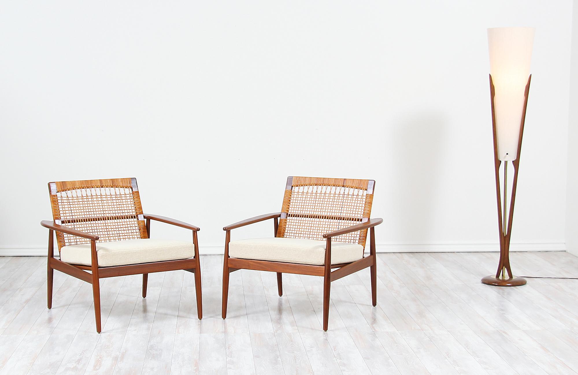 Pair of Danish modern lounge chairs designed by Hans Olsen for Juul Kristensen in Denmark, circa 1960s. This iconic chair design by Hans Olsen is constructed from solid Afromosia teak wood that is found only in Africa, its original Danish woven
