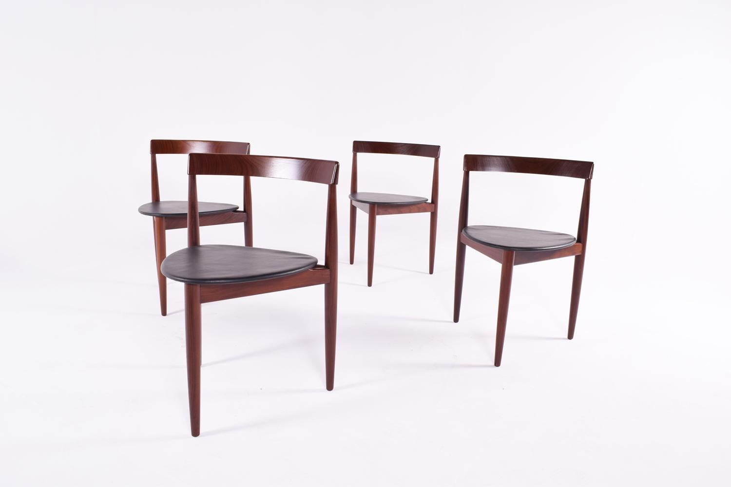 Set of four dining chairs of Hans Olsen for Frem Rojle. This triangle Chairs are in Teak and with black faux leather. Signed. 
Produced by Frem Røjle, model Roundette.