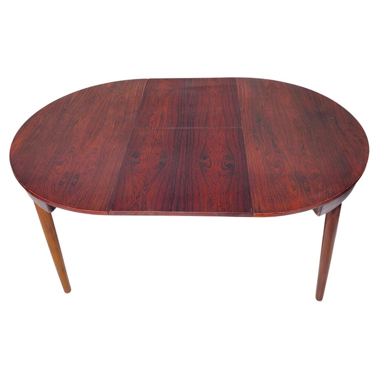 Dining table designed by Hans Olsen. Made in Denmark by Frem Røjle. Branded. Rosewood top. Wenge legs and sliding support structure.
Just over 60
