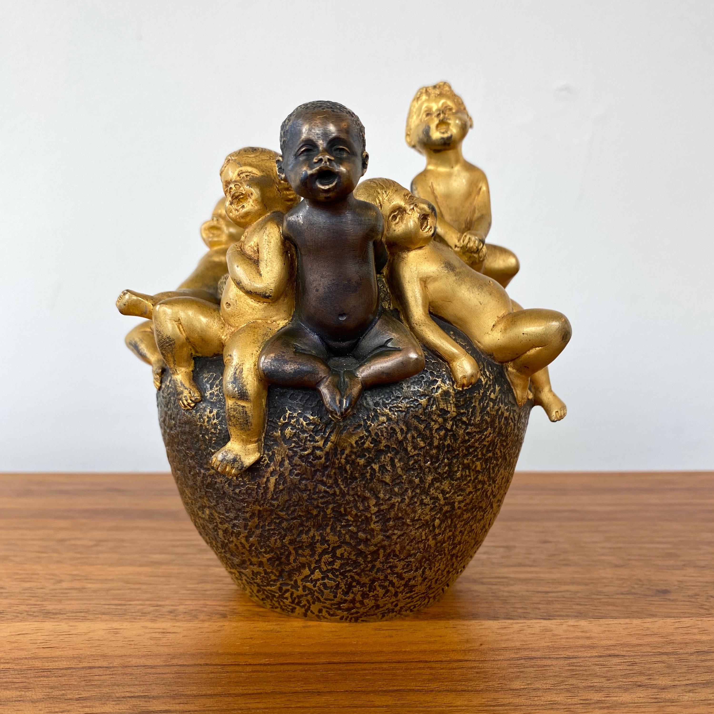 A diminutive and delightful circa 1900 Art Nouveau putti form gilt and patinated bronze figural vase by German sculptor Hans Stoltenberg-Lerche (b. 1867–1920), as realized by Parisian foundry and finisher Louchet Ciseleur.

A half-dozen cheerful,