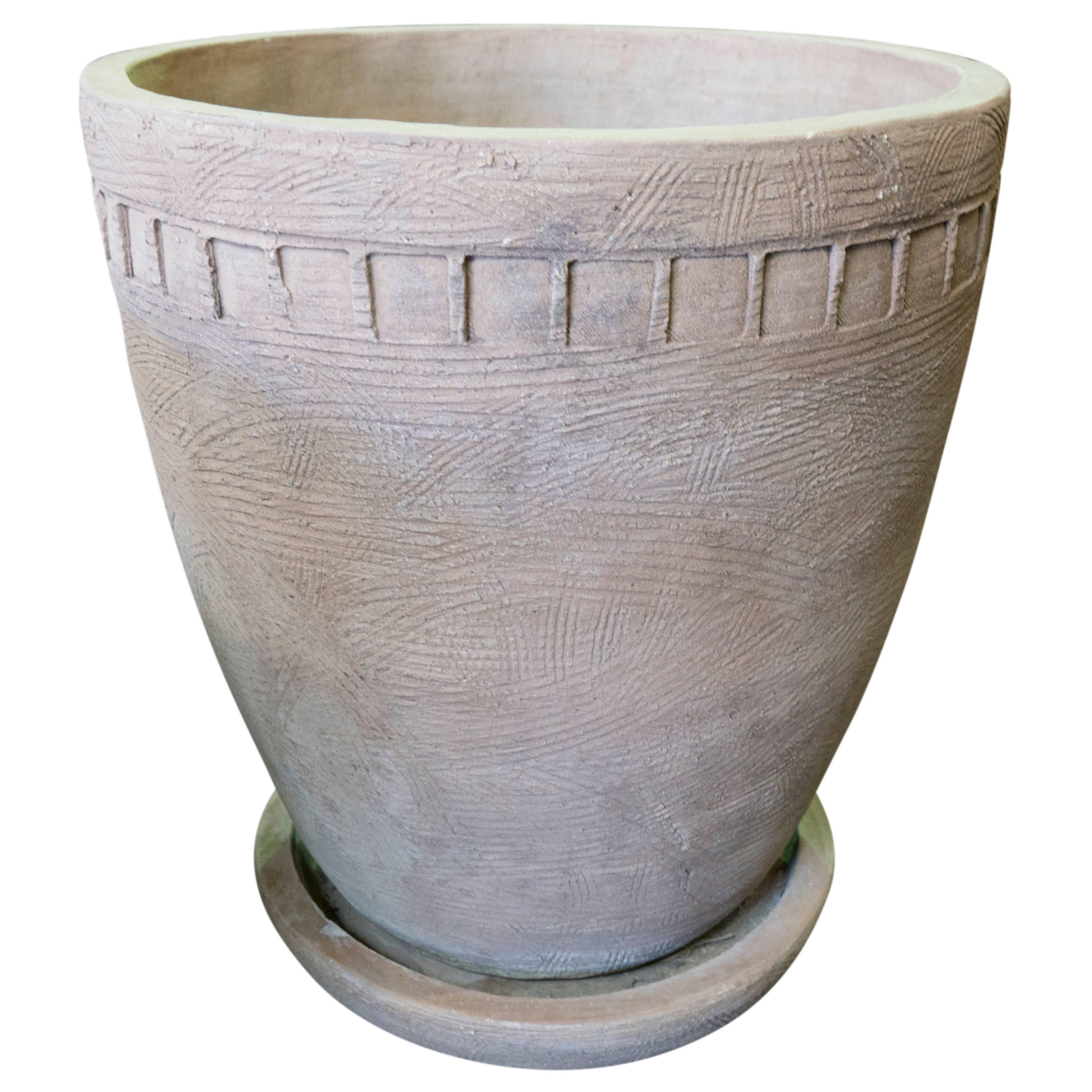 A piece of modern garden art hand built in California by Hans Sumpf in the late 1970s. This beautiful planter features square incised decoration around the body, and comes with a saucer custom designed to accompany the vessel.