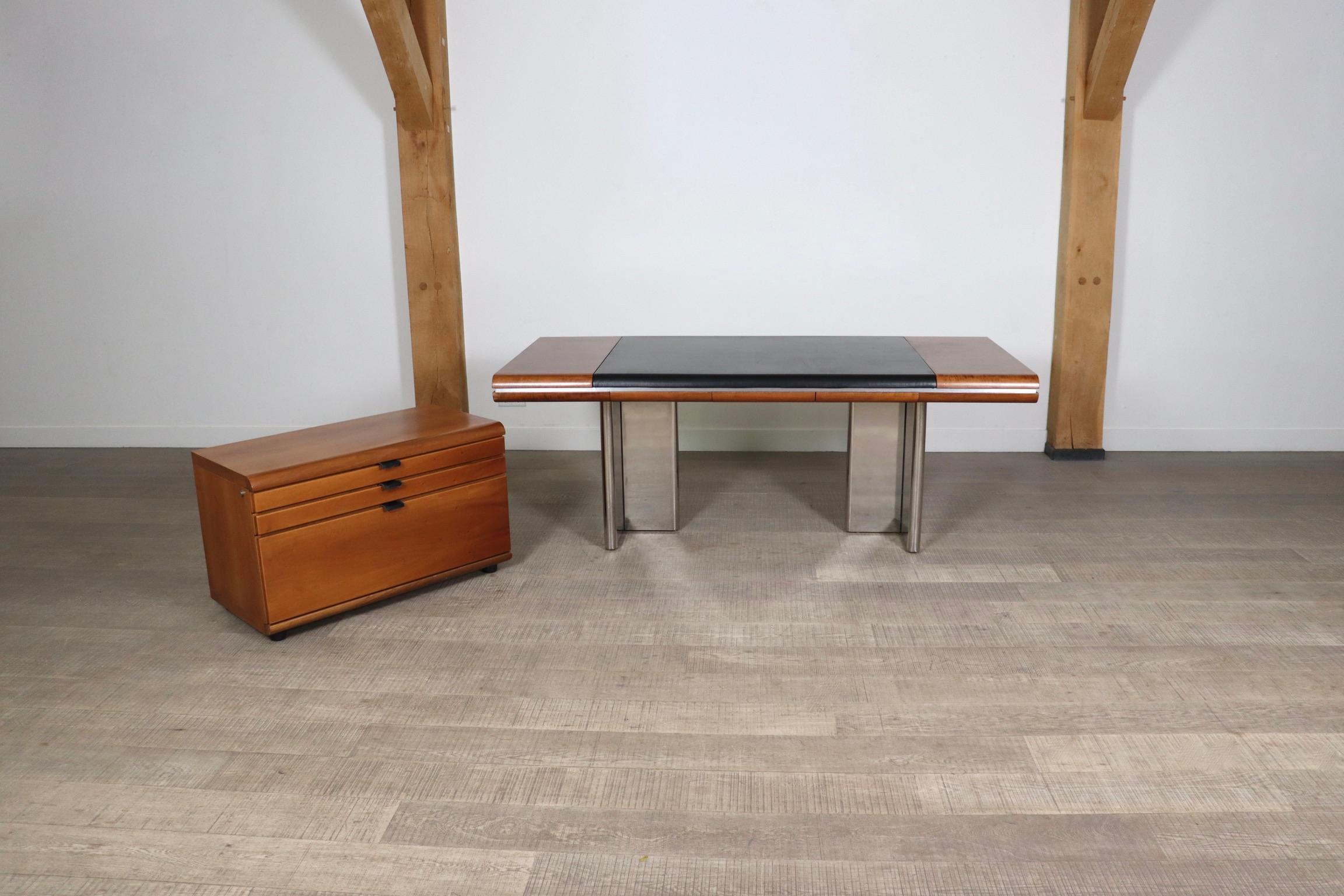 Impressive executive desk and matching credenza designed by Hans von Klier in the 1970s. A striking combination of differently textured materials in three colors makes this desk an intriguing piece. The two t-shaped legs in chromed metal add a