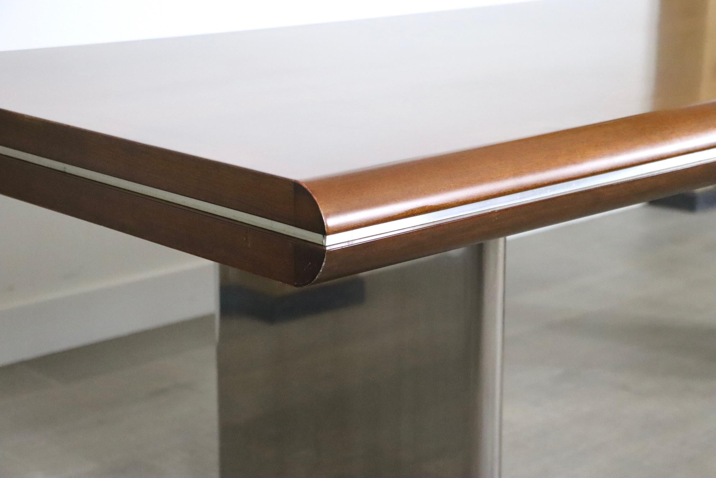 Impressive directors desk designed by Hans von Klier. A striking combination of differently textured materials in two colors makes this desk an intriguing piece. The two t-shaped legs in chromed metal add a highly modern and also architectural