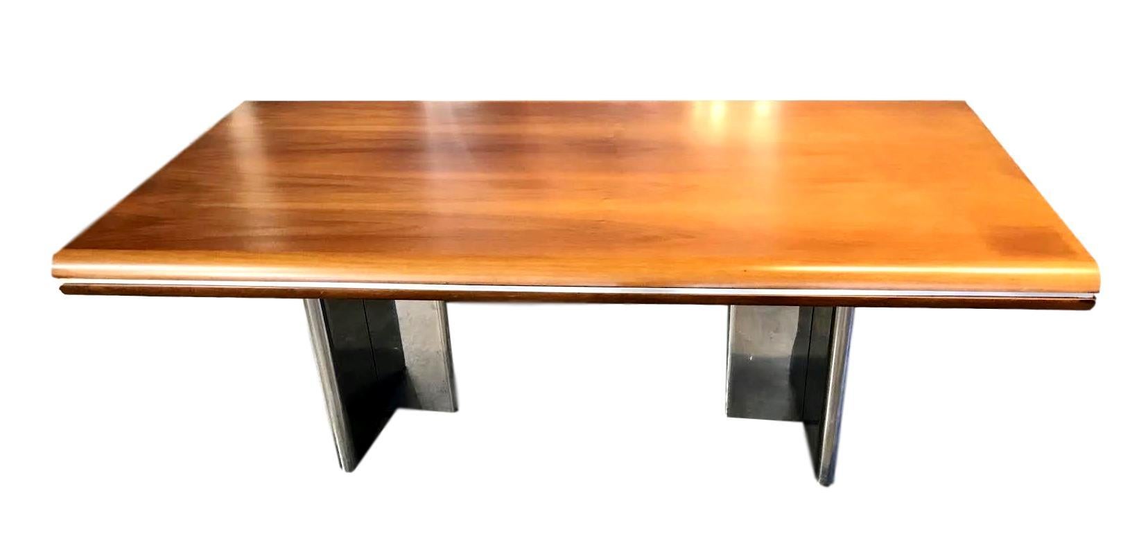 Stunning desk by Hans Von Klier for Skipper. Made in Italy in 1970. Walnut top with three hidden pullout / pull-out drawers. Two polished chrome pedestal bases flank each side. Matching credenza available in separate listing. Hans passed away in