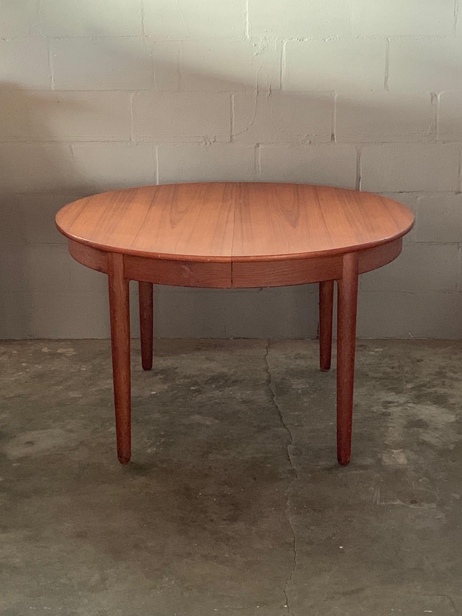 A Classic teak round dining table by Hans Wegner, manufactured by Andreas Tuck, circa 1950s. Comes with three leaves-total extention approx. 117